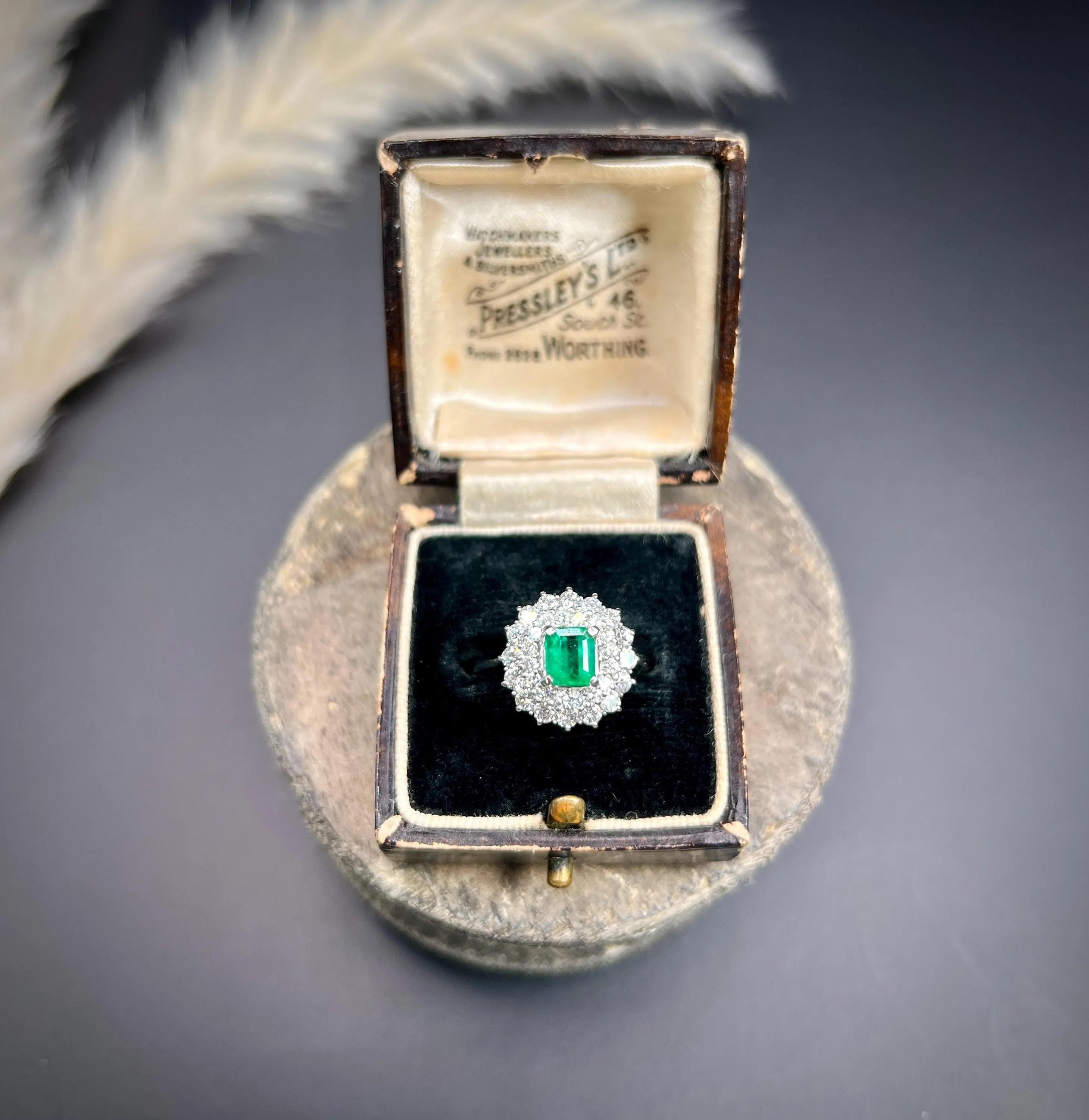 Vintage Emerald & Diamond Ring

Platinum

Circa 1980

Step into elegance with this exquisite vintage cluster ring from the 1980s. At its centre, it boasts a beautifully crafted rectangular-cut natural emerald, radiating a rich, vibrant green hue