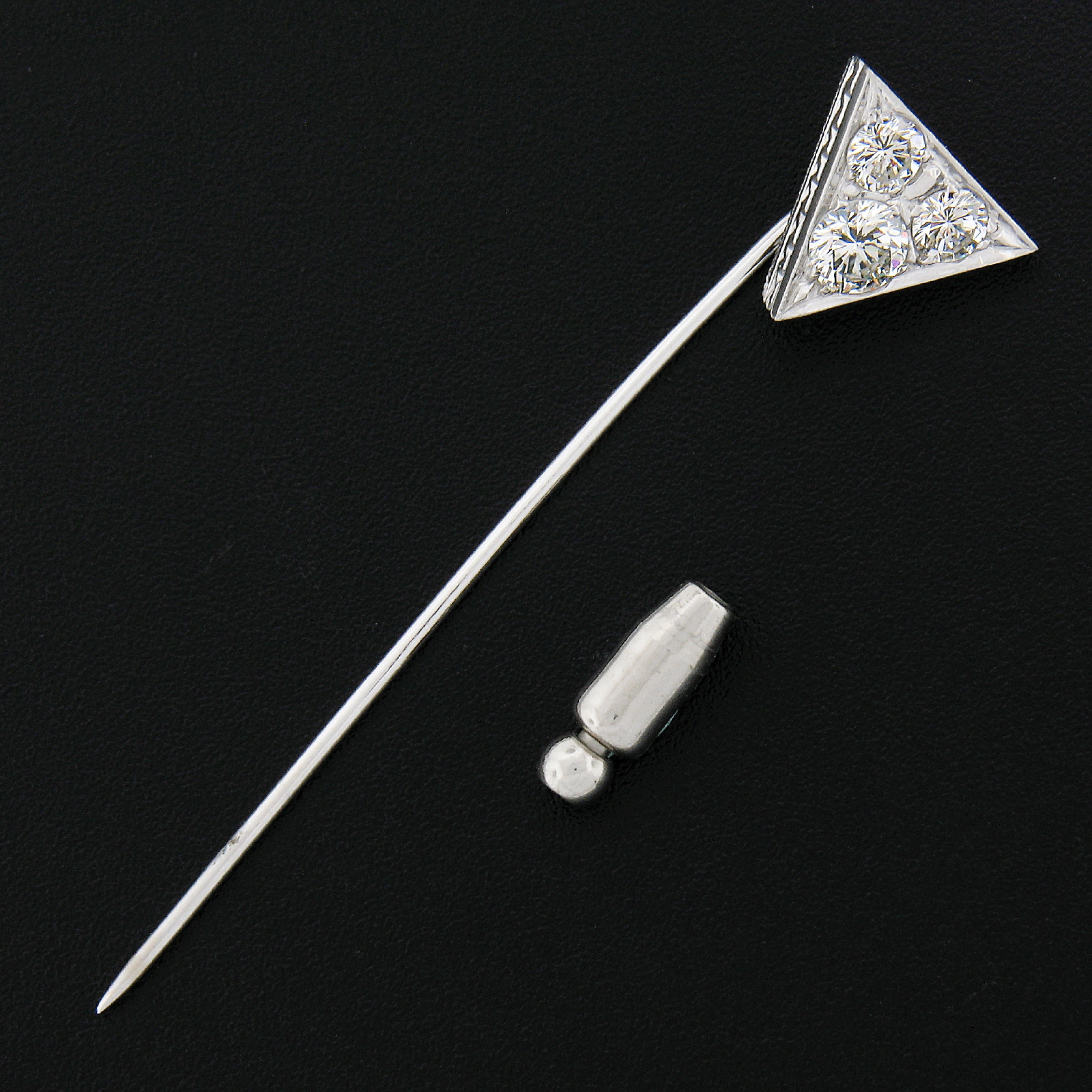 This gorgeous vintage midcentury stick pin was crafted in solid platinum and features a triangle shaped design that is neatly pave set with 3, large, round brilliant diamonds. These diamonds are each a nice size, totaling approximaltey 1 carat in