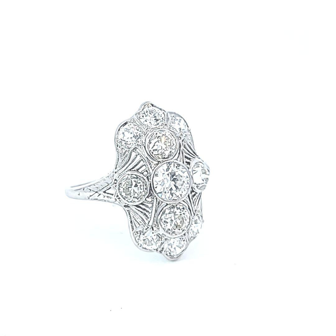 2.15 carats of diamonds are in this platinum Art Deco setting with filigree detail and etched sides.  