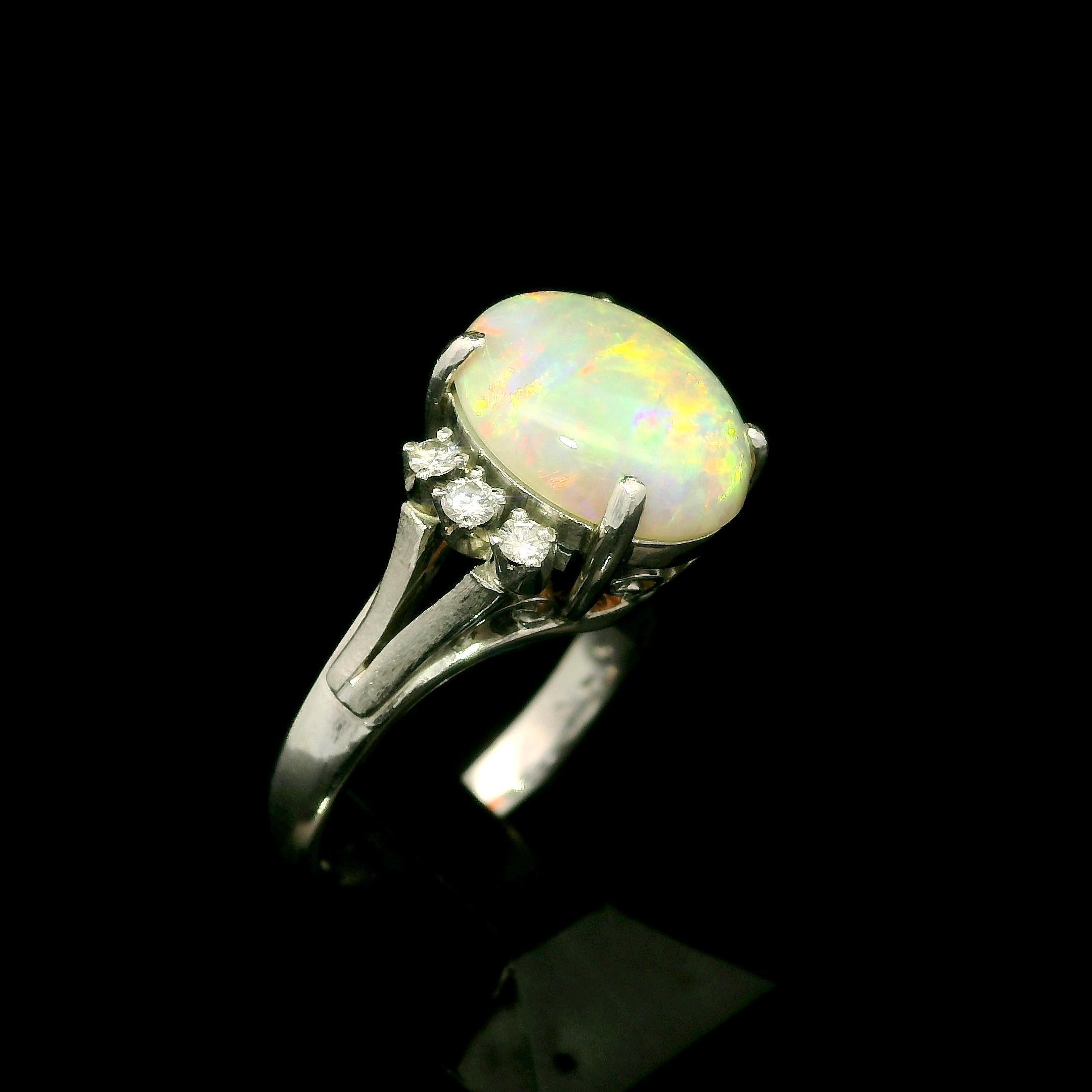 --Stone(s):--
(1) Natural Genuine Opal - Oval Cabochon Cut - Prong Set - White Color w/ Very Nice Play of Colors - 11.5x9.4mm / 2.36ct (exact)
(6) Natural Genuine Diamonds - Round Brilliant Cut - Prong Set - G-I Color - VS-SI Clarity - 0.15ctw