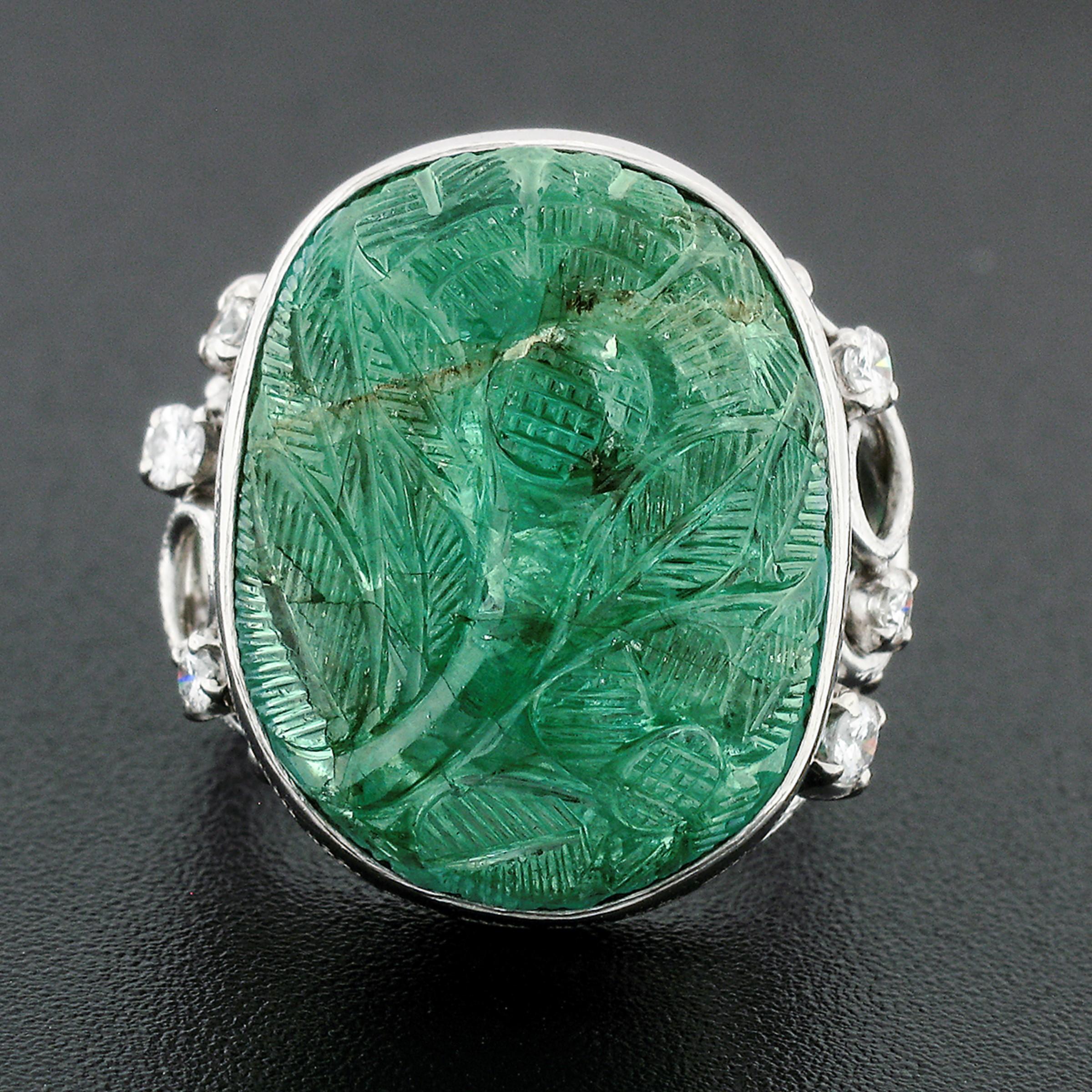 This truly gorgeous, vintage, GIA certified emerald and round diamond statement ring was crafted from solid .900 platinum. The ring features a breathtaking, natural, oval cut emerald that displays a rich medium green color and a magnificently