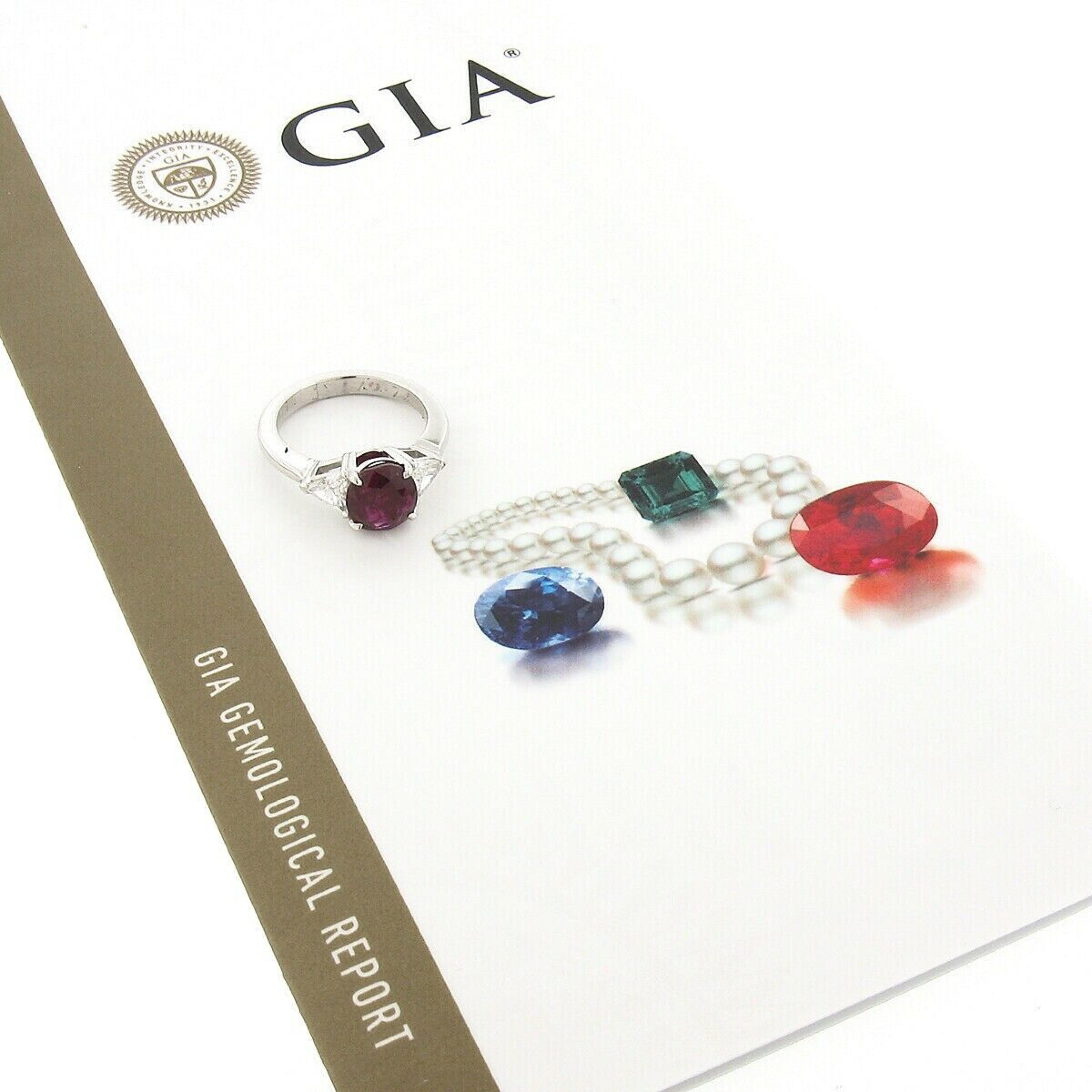 This outstanding vintage ring was crafted from solid platinum and features a gorgeous, 2.48 carat, GIA certified red ruby solitaire neatly prong set at its center. This magnificent oval brilliant cut ruby displays a gorgeous deep red color that