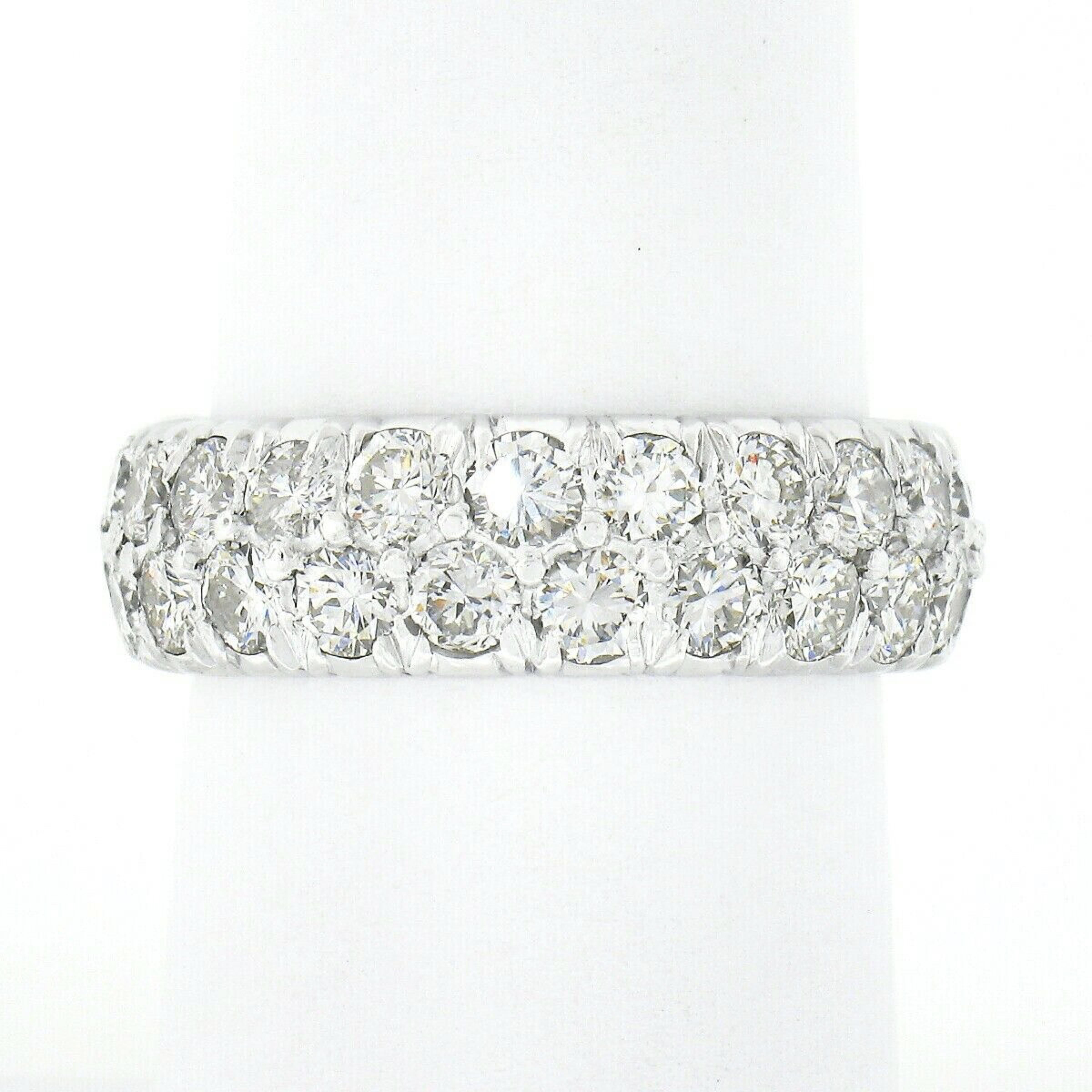 This here is a classic and elegant vintage diamond eternity band crafted in solid platinum. The ring features approximately 3.50 carats of top quality round brilliant cut diamonds that are true hand pave set throughout the entire band in a dual row