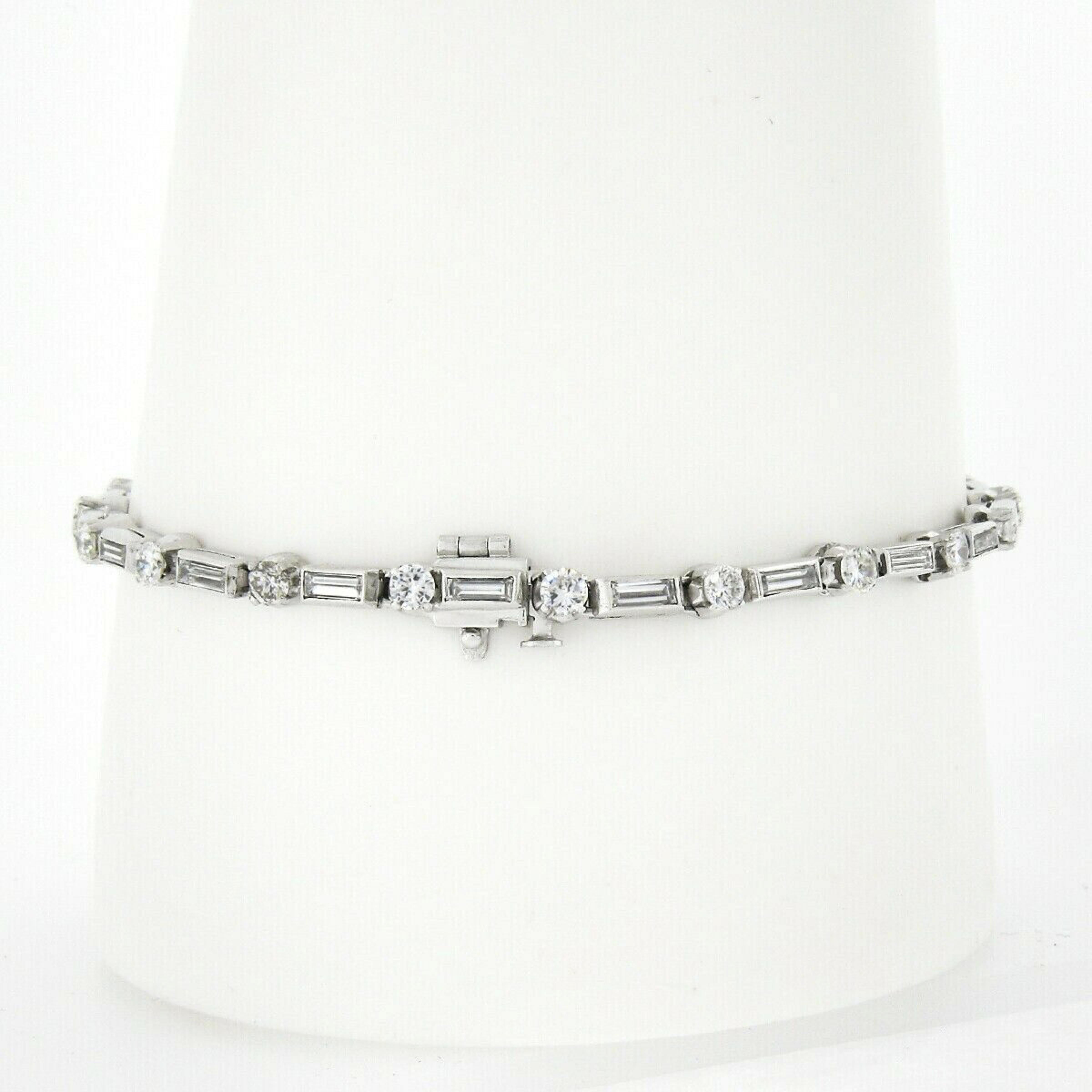 This breathtaking vintage diamond tennis bracelet is crafted in solid platinum and features approximately 3.80 carats of super fine quality diamonds throughout. It features an elegant design that alternates with a prong set round brilliant cut