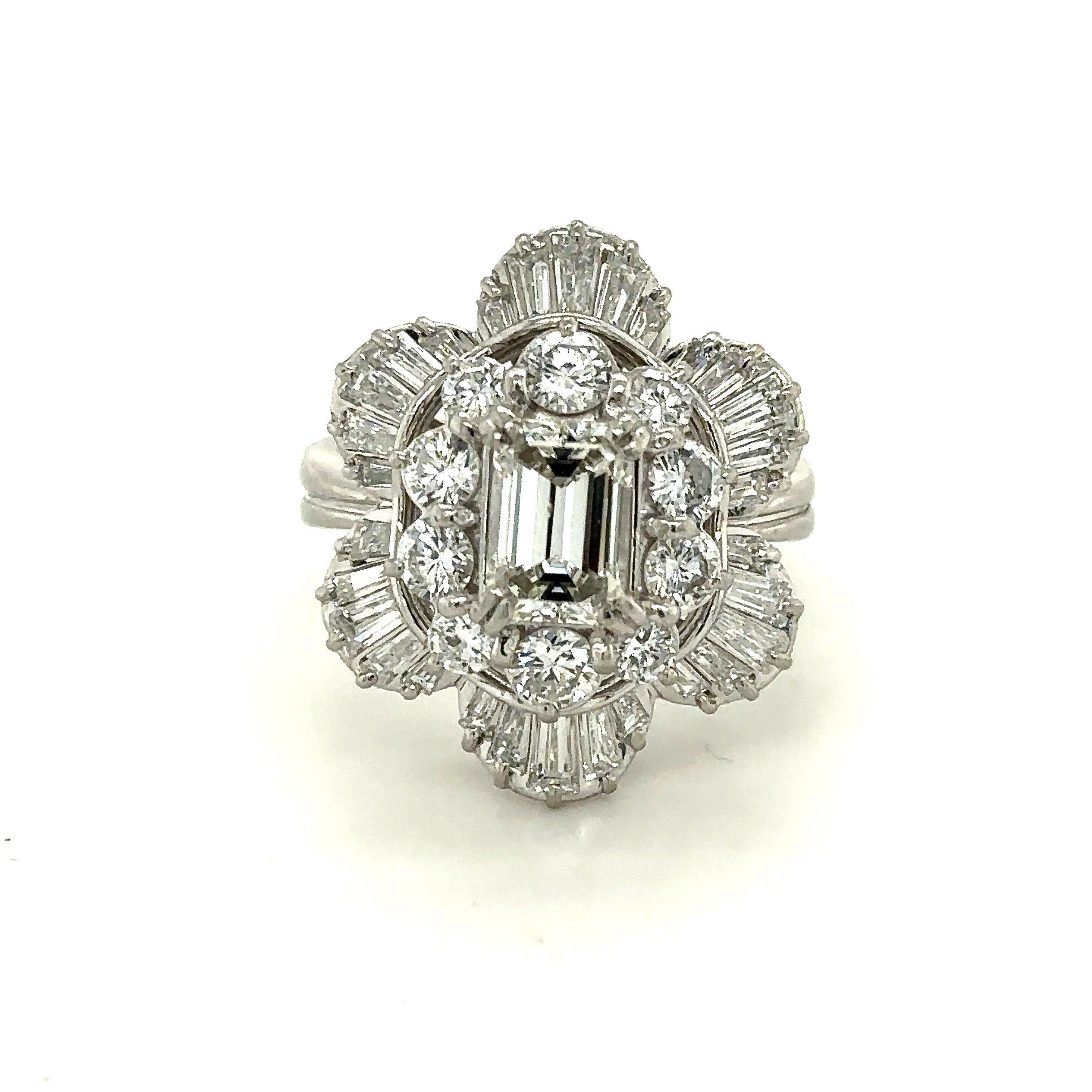 Vintage Platinum 3CT diamond floral cocktail ring. This 1950s-era vintage platinum and diamond cocktail ring features 3CT diamonds in a floral design. The center diamond is a 1.21CT emerald-cut diamond, J Color, SI2 Clarity with a GIA lab report.