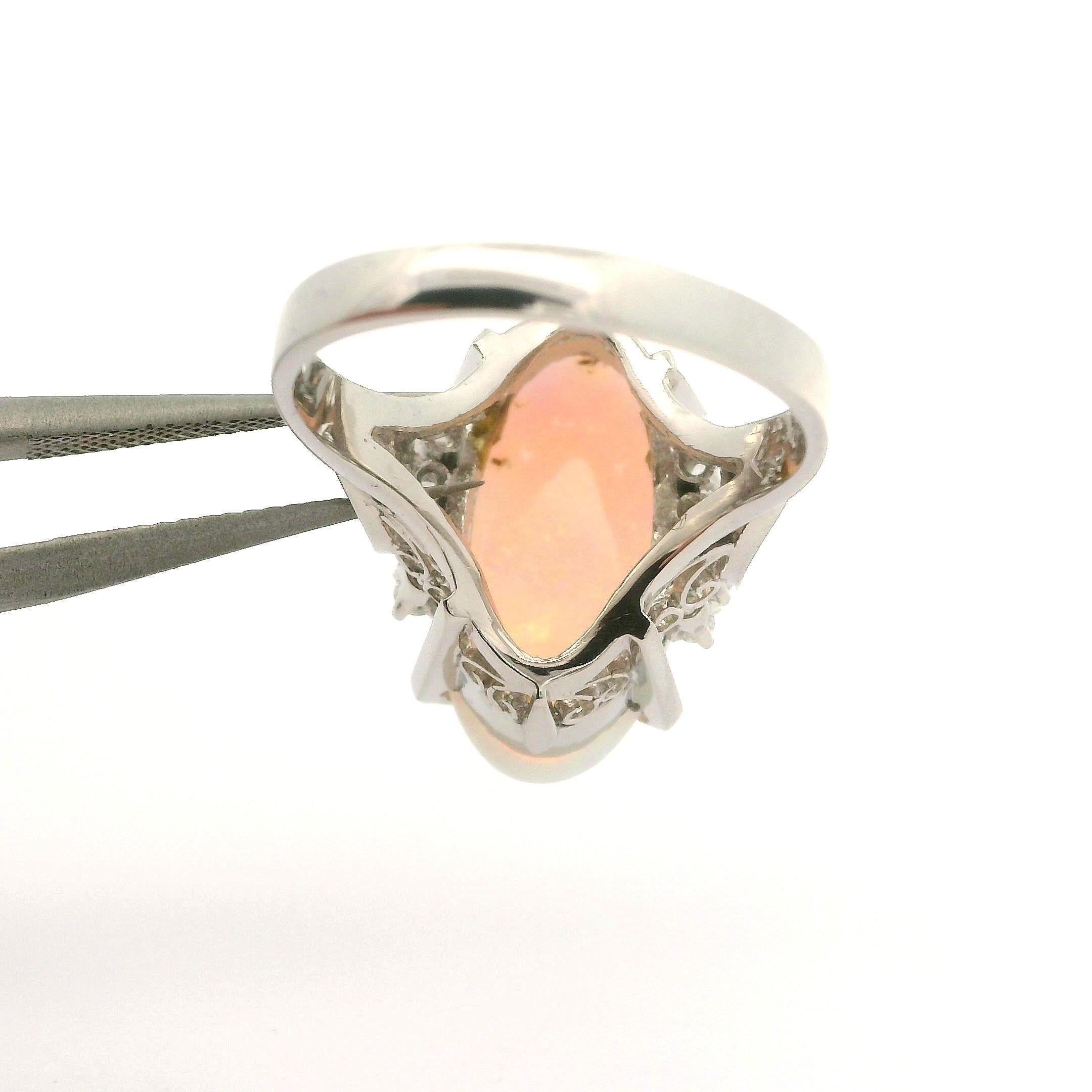 --Stone(s):--
(1) Natural Genuine Opal - Elongated Oval Cabochon Cut - Prong Set - White Color w/ Very Nice Play of Colors - 19.3x9.8mm / 4.39ct (exact, stamped)
(8) Natural Genuine Diamonds - Round Brilliant Cut - Prong Set - Very Nice Brilliant