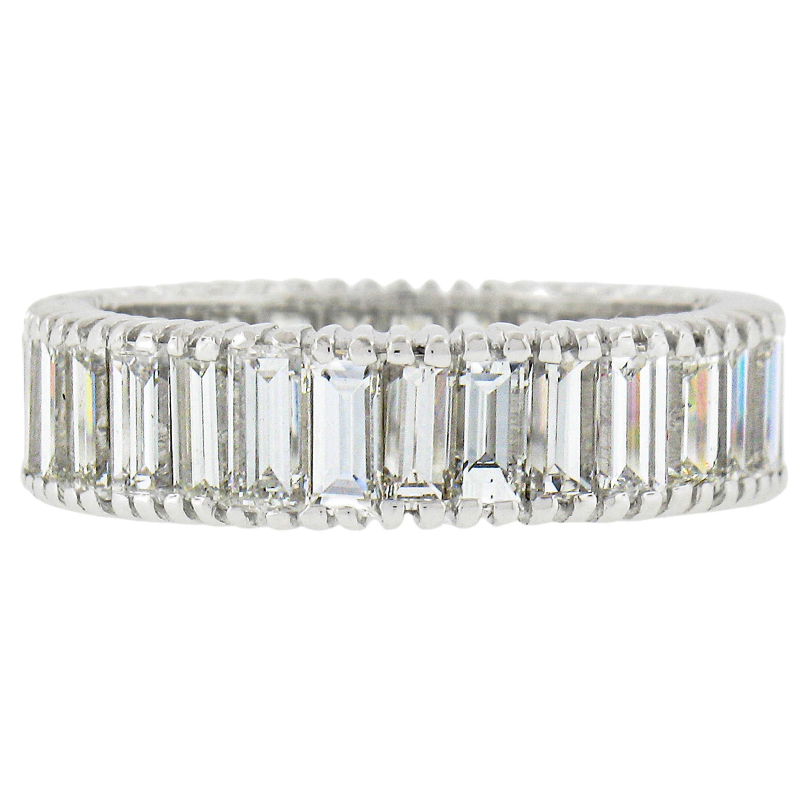 This absolutely stunning and very well made vintage diamond eternity band is crafted in solid platinum and features very fine quality straight baguette cut diamonds neatly prong set entirely around the ring. The ring contains 31 diamonds which total