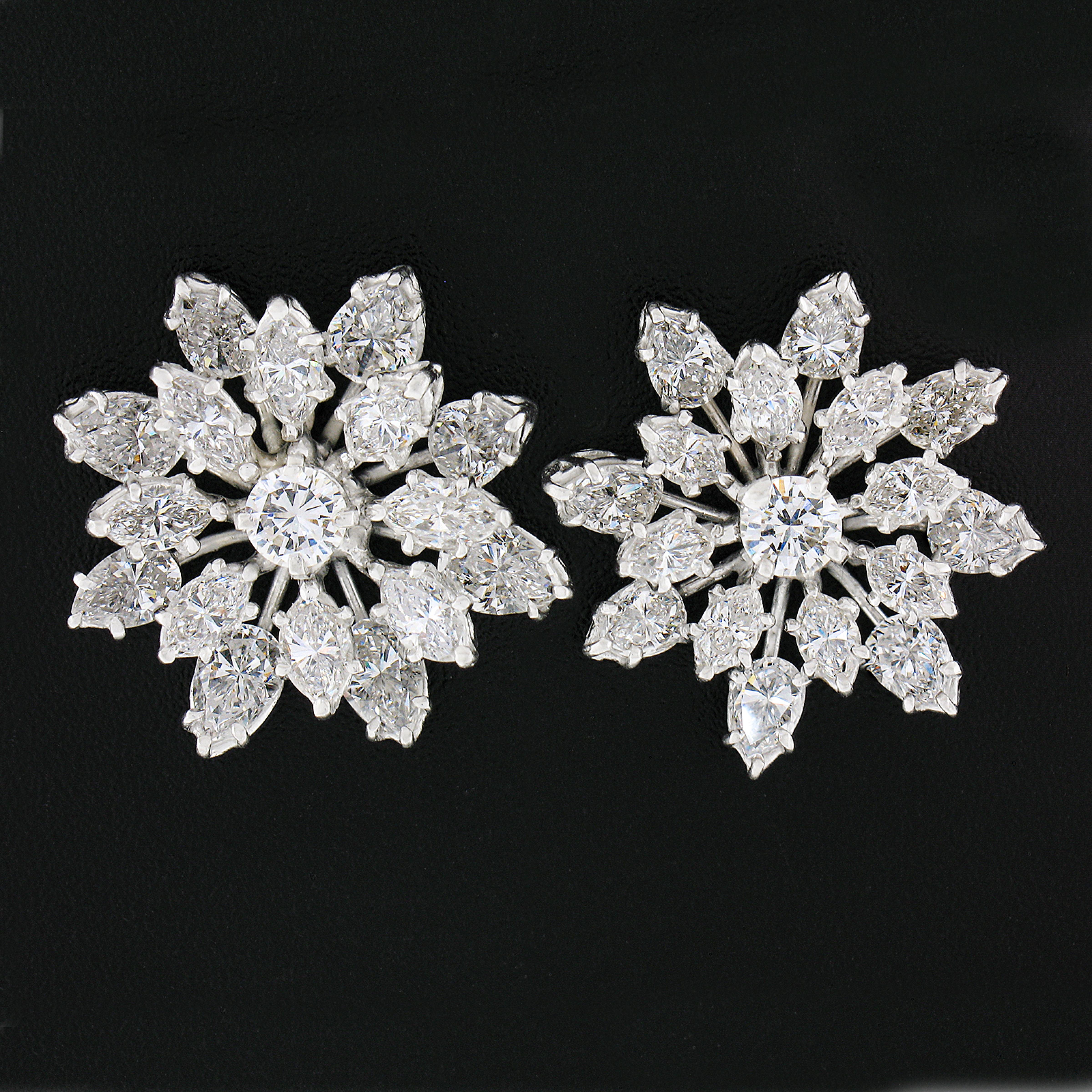 Here we have a jaw dropping pair of vintage earrings crafted from solid platinum featuring a magnificent snowflake spray design drenched with approximately 4.84 carats of super fine quality diamonds throughout. The prong set stones sit in individual