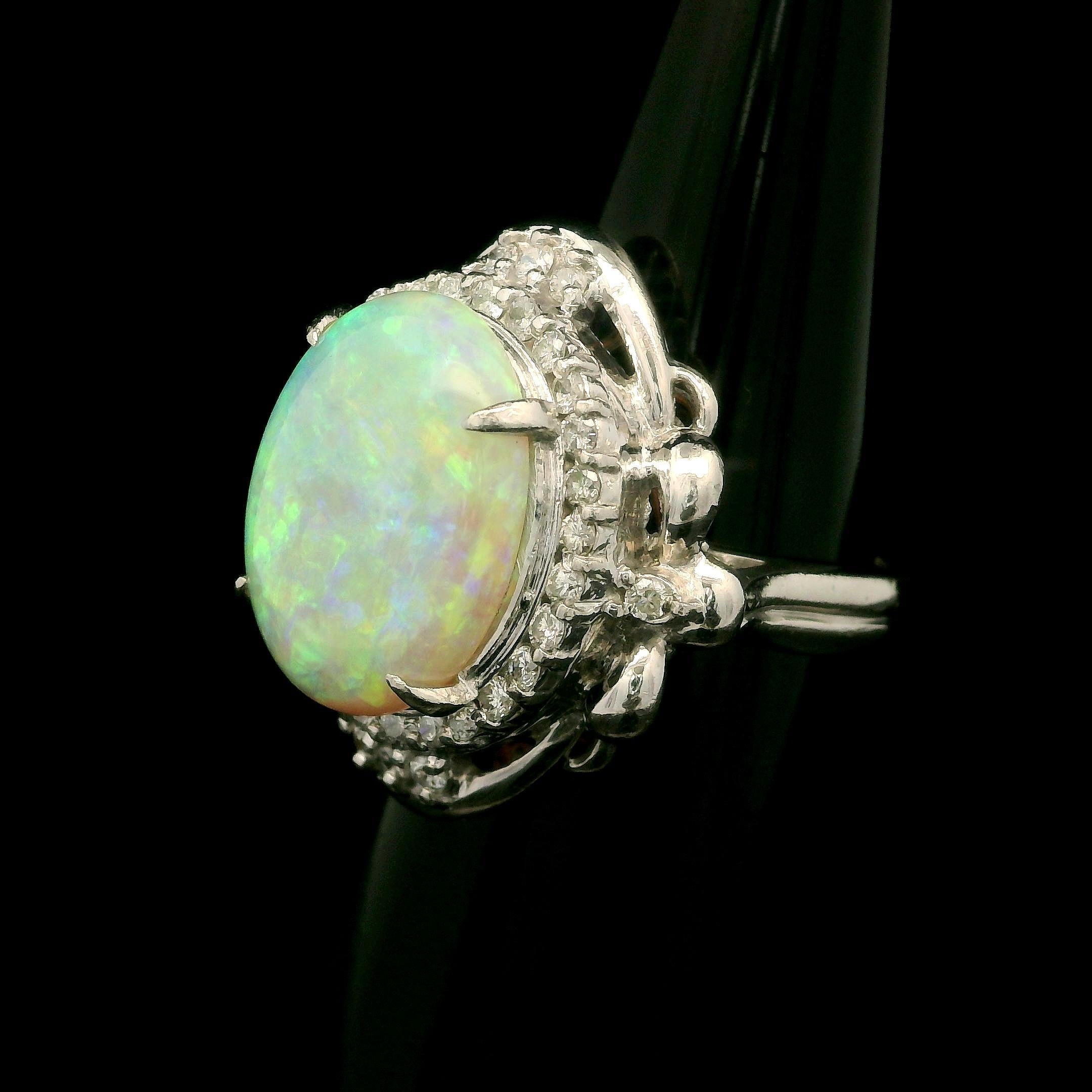 --Stone(s):--
(1) Natural Genuine Opal - Oval Cabochon Cut - Prong Set - White Color w/ Very Nice Play of Colors - 14.6x11.3mm / 4.41ct (exact)
Numerous Natural Genuine Diamonds - Round Brilliant Cut - Prong Set - Nice White Color - 0.47ctw