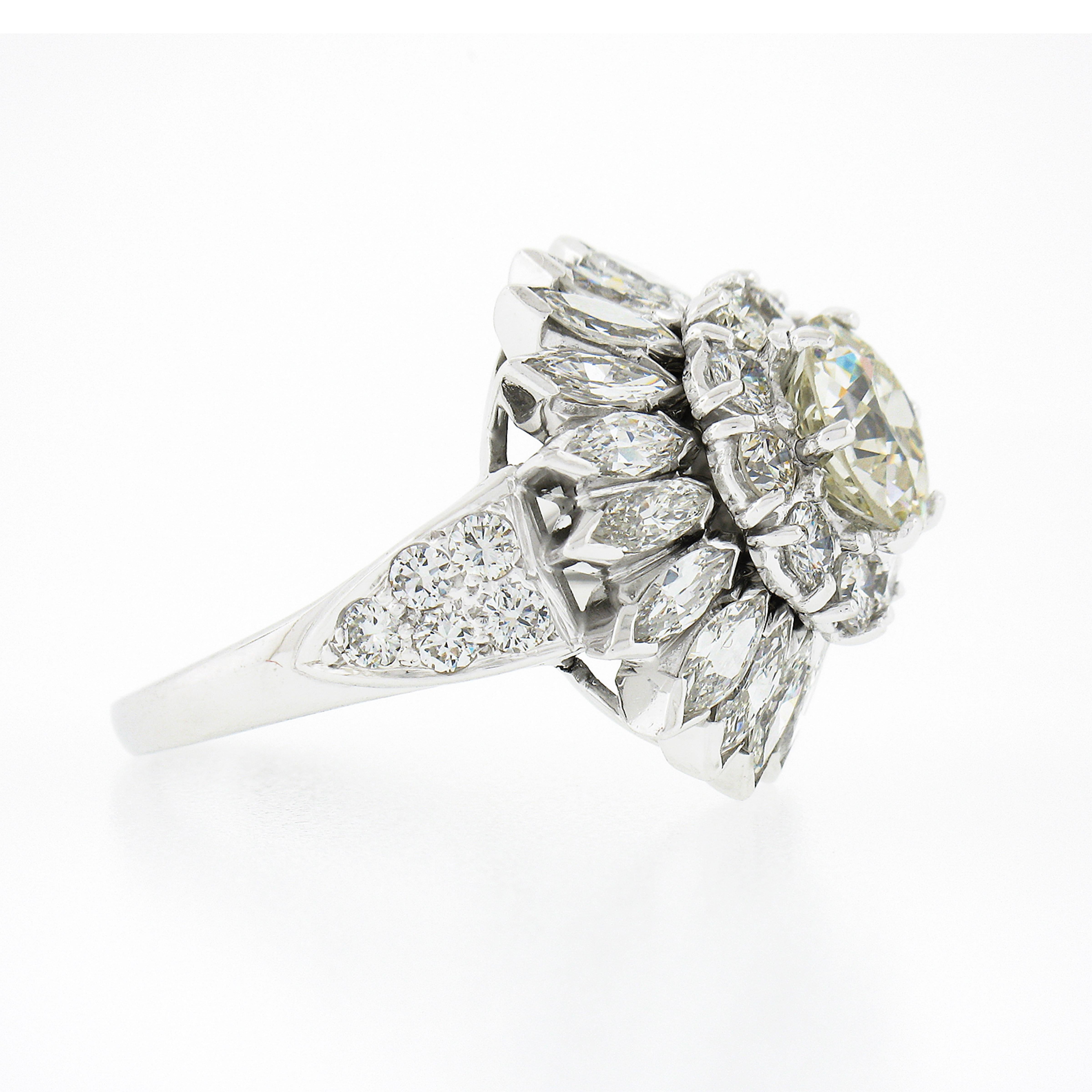 This truly jaw dropping engagement or cocktail diamond ring is crafted in solid platinum and is completely drenched in very fine quality diamonds throughout this incredible and substantial design. It features a gorgeous, GIA certified, old European