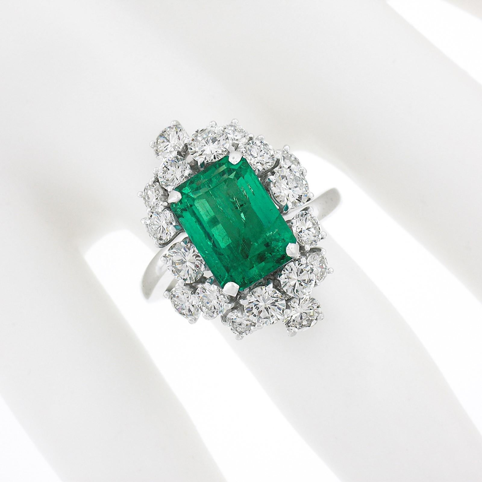 Vintage Platinum 6.49ctw GIA Columbian Emerald W/ Diamond Cluster Cocktail Ring In Good Condition In Montclair, NJ