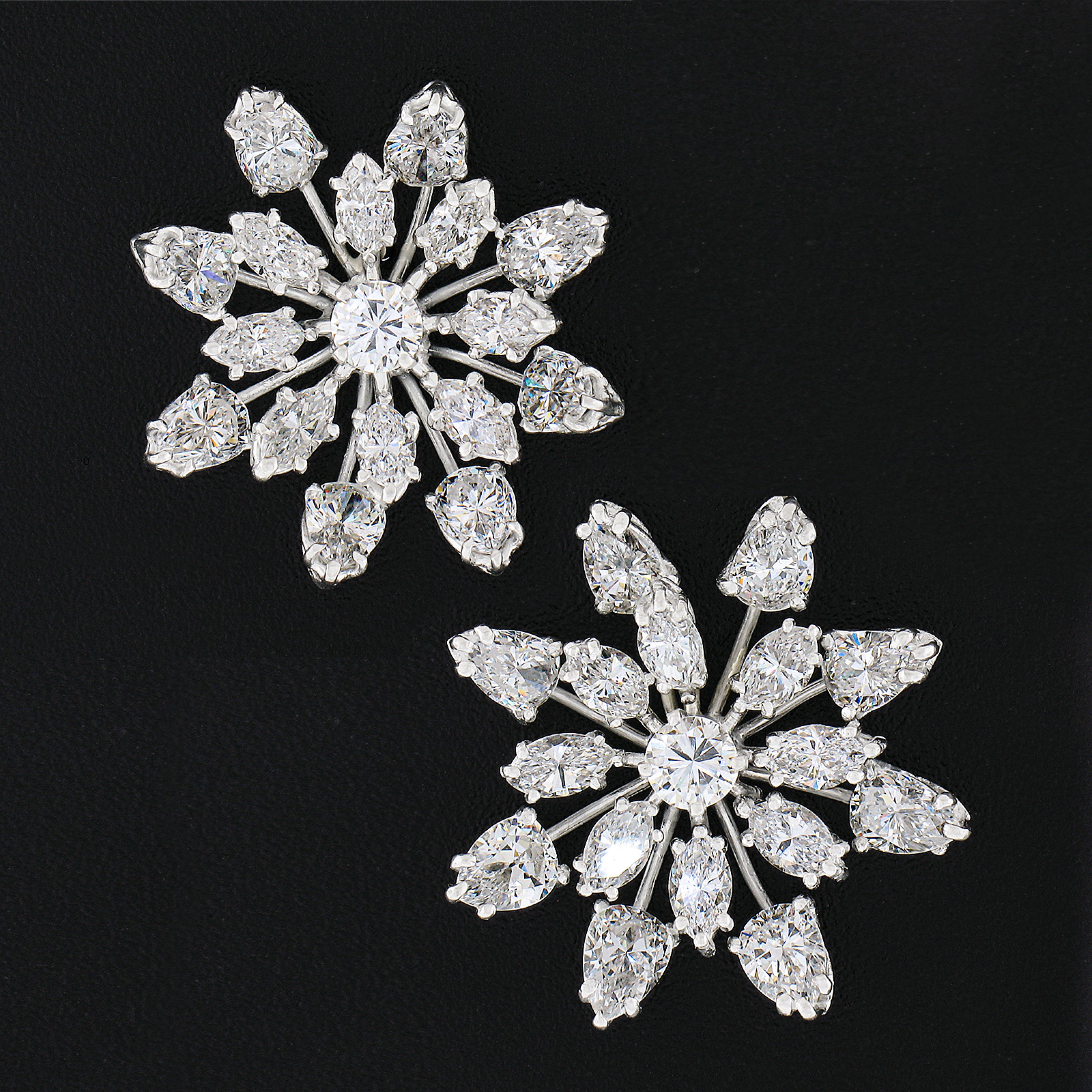 Here we have a jaw dropping pair of vintage earrings crafted from solid platinum featuring a magnificent snowflake spray design drenched with approximately 6.40 carats of super fine quality diamonds throughout. The prong set stones sit in individual