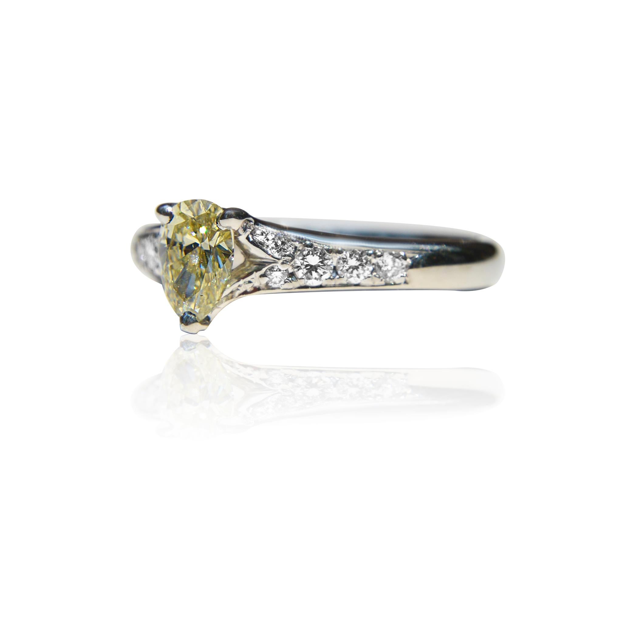 Modern Vintage Platinum .71 Carat Fancy Light Yellow Pear Diamond Engagement Ring For Sale