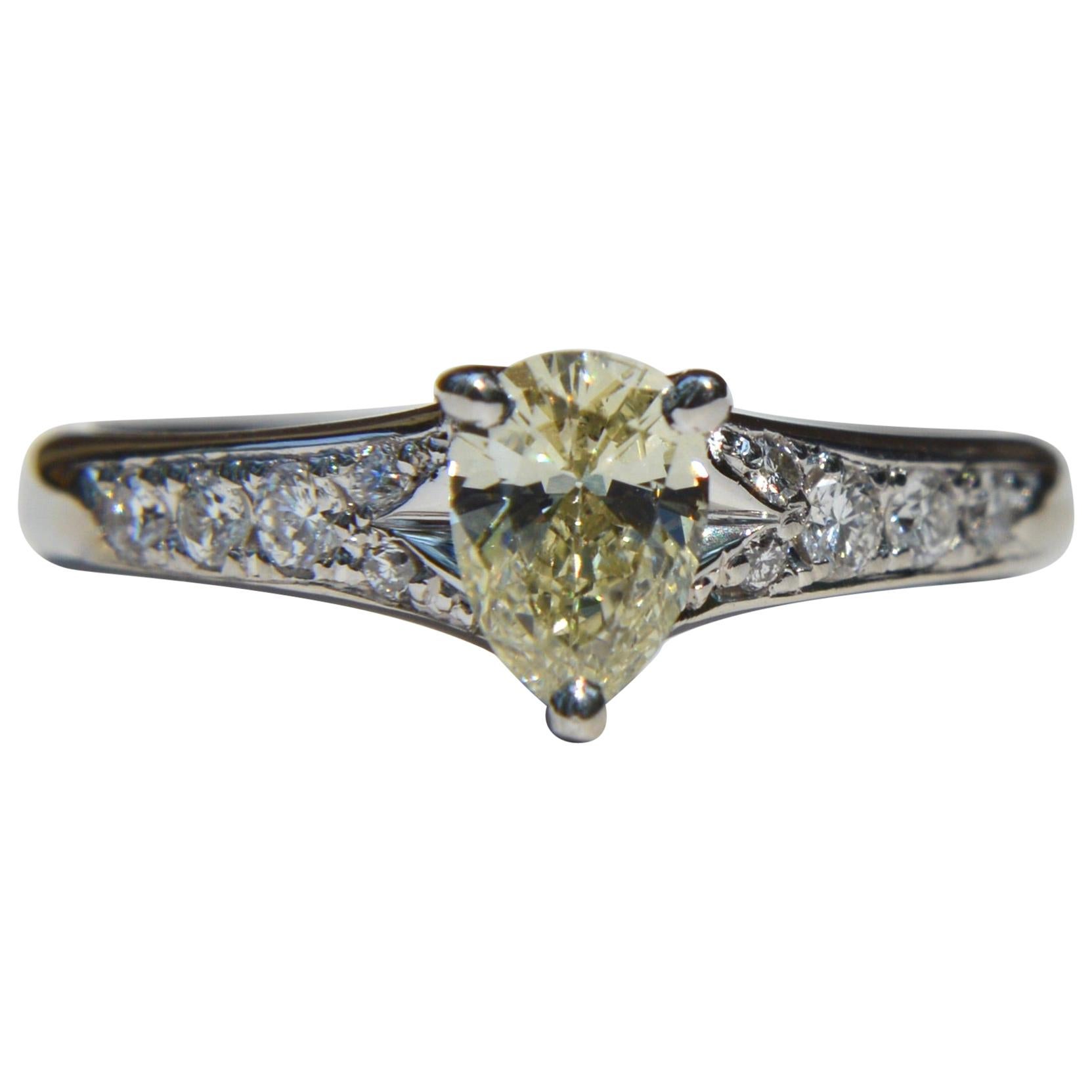 Vintage Platinum .71 Carat Fancy Light Yellow Pear Diamond Engagement Ring For Sale