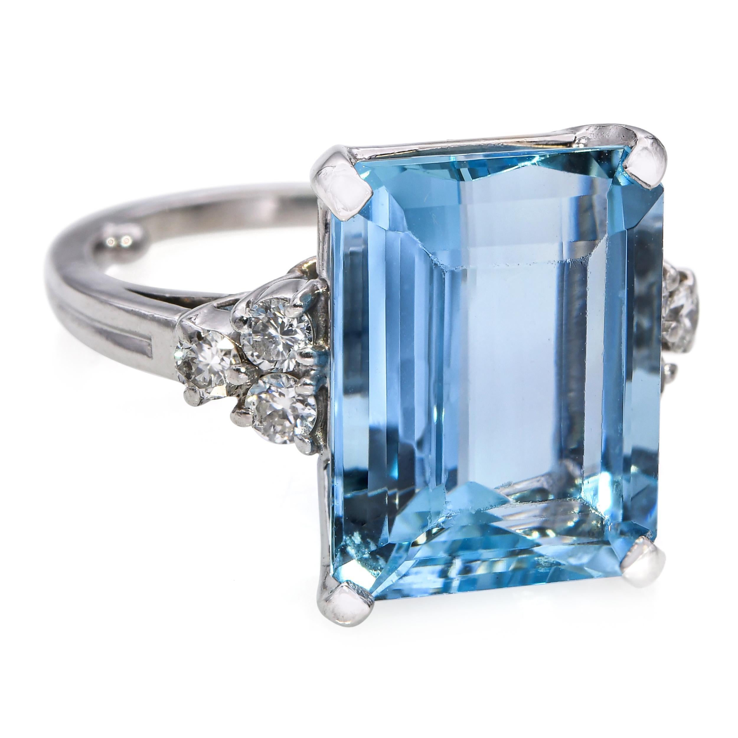 This vintage platinum cocktail ring showcases a stunning 7.50ct aquamarine at its center, radiating a vivid, crystalline blue hue characteristic of fine-quality stones. The aquamarine is accented by 0.18tcw of sparkling diamonds, adding a refined