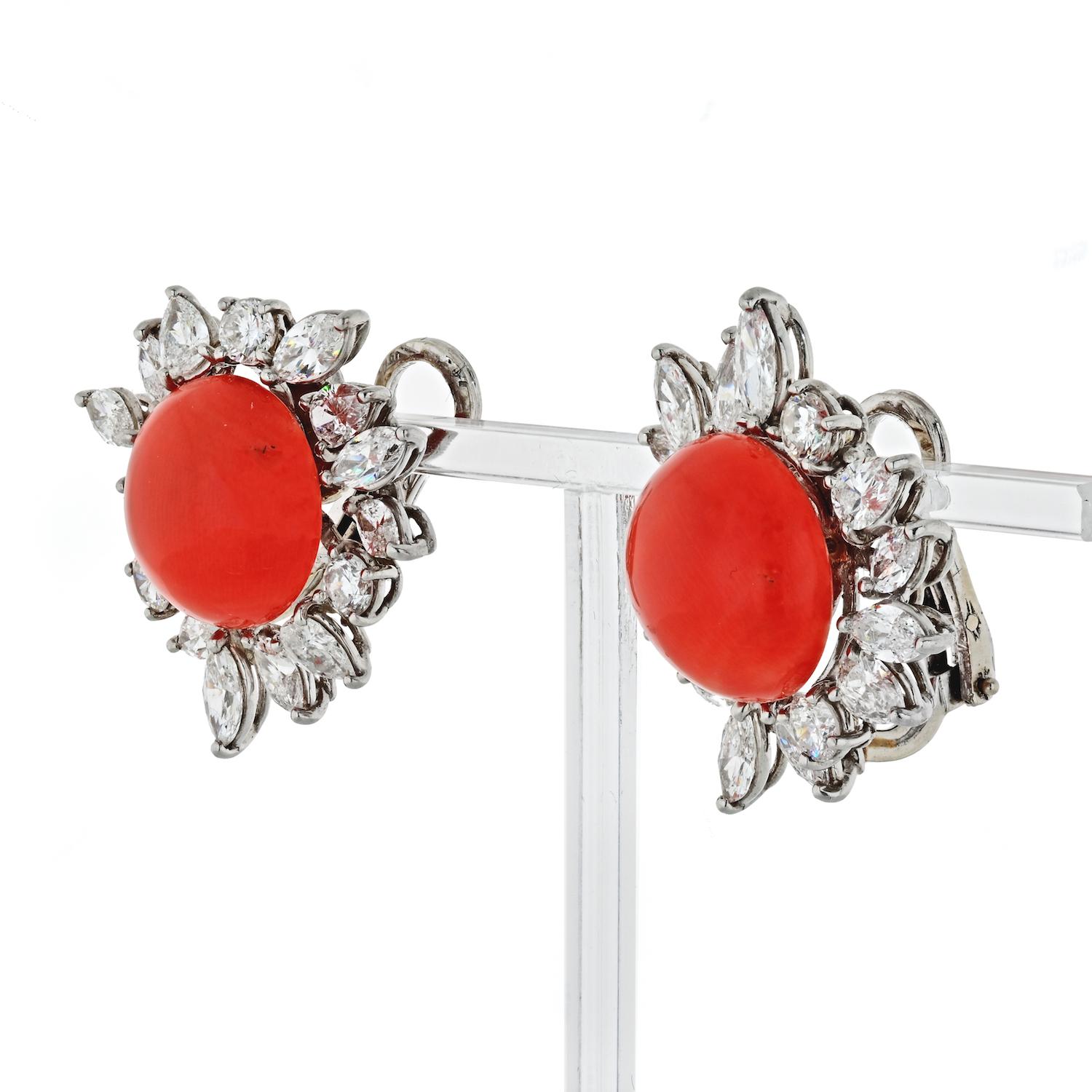Crafted in platinum these beautiful earrings were produced in 1960's set with pear-cuts, marquise cuts and round diamonds. Center corals are of round cabochon cuts. Bright orange color. 
Diamond total carat weight: 6.00cts. 
Circa 1960's 
Clip on