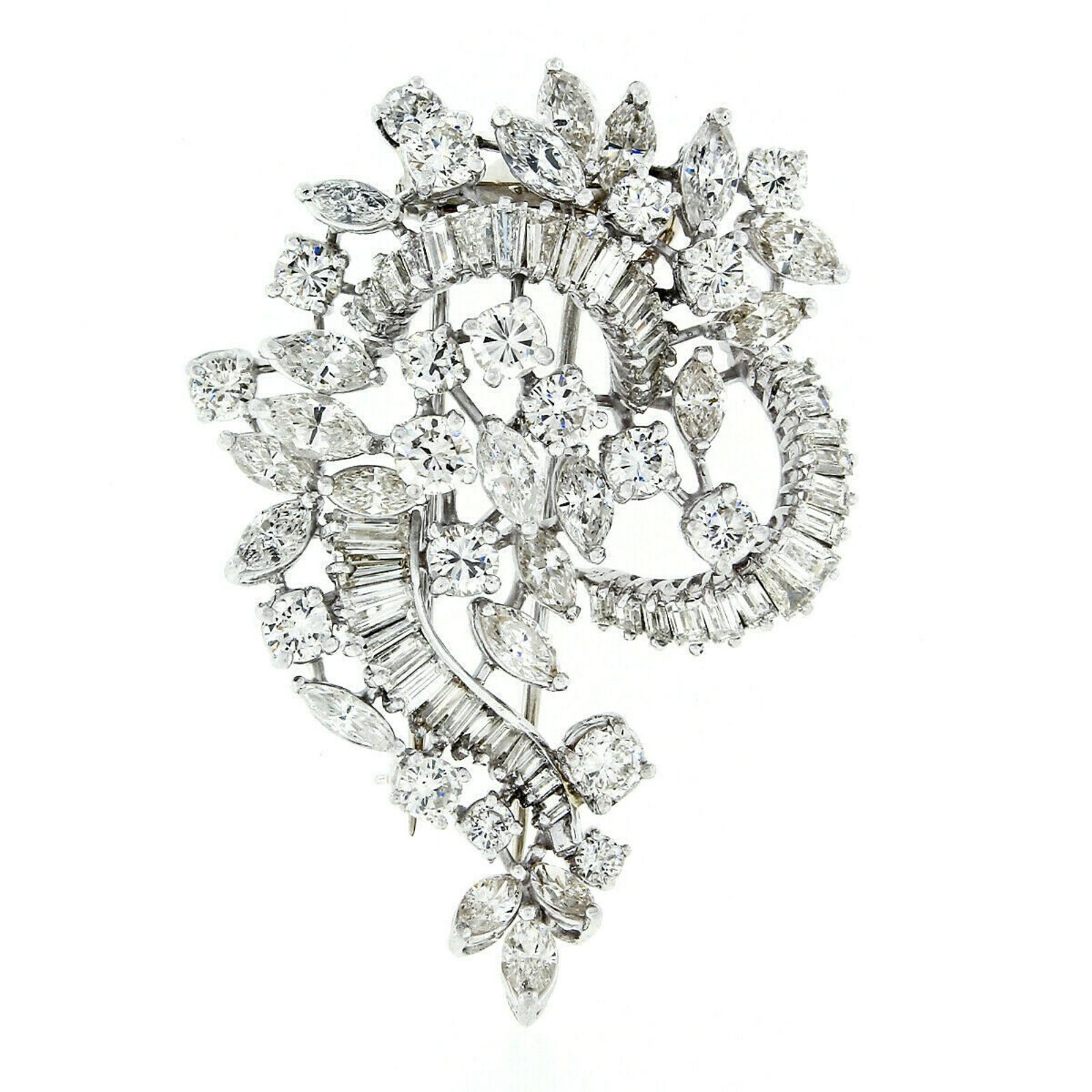 This magnificent and unique diamond brooch was hand crafted from solid platinum and is drenched with approximately 8.85 carats of fine quality and remarkably brilliant diamonds throughout. The brooch has a free-form spray or floral-like design