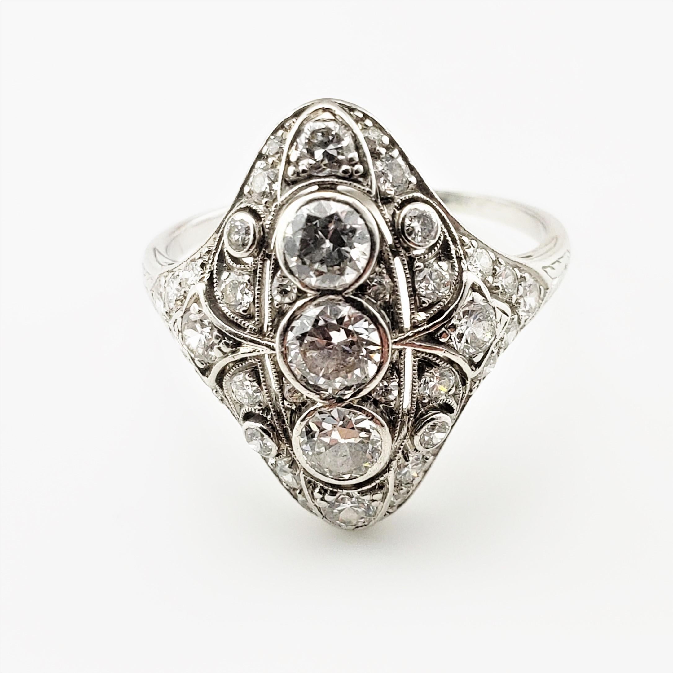 Vintage Platinum and Diamond Filigree Ring Size 9.5 GAI Certified-

This stunning ring features 33 round brilliant cut diamonds set in exquisitely detailed platinum filigree.  (center stones; .25 ct., .30 ct., .22 ct.).  Top of ring measures 21 mm x