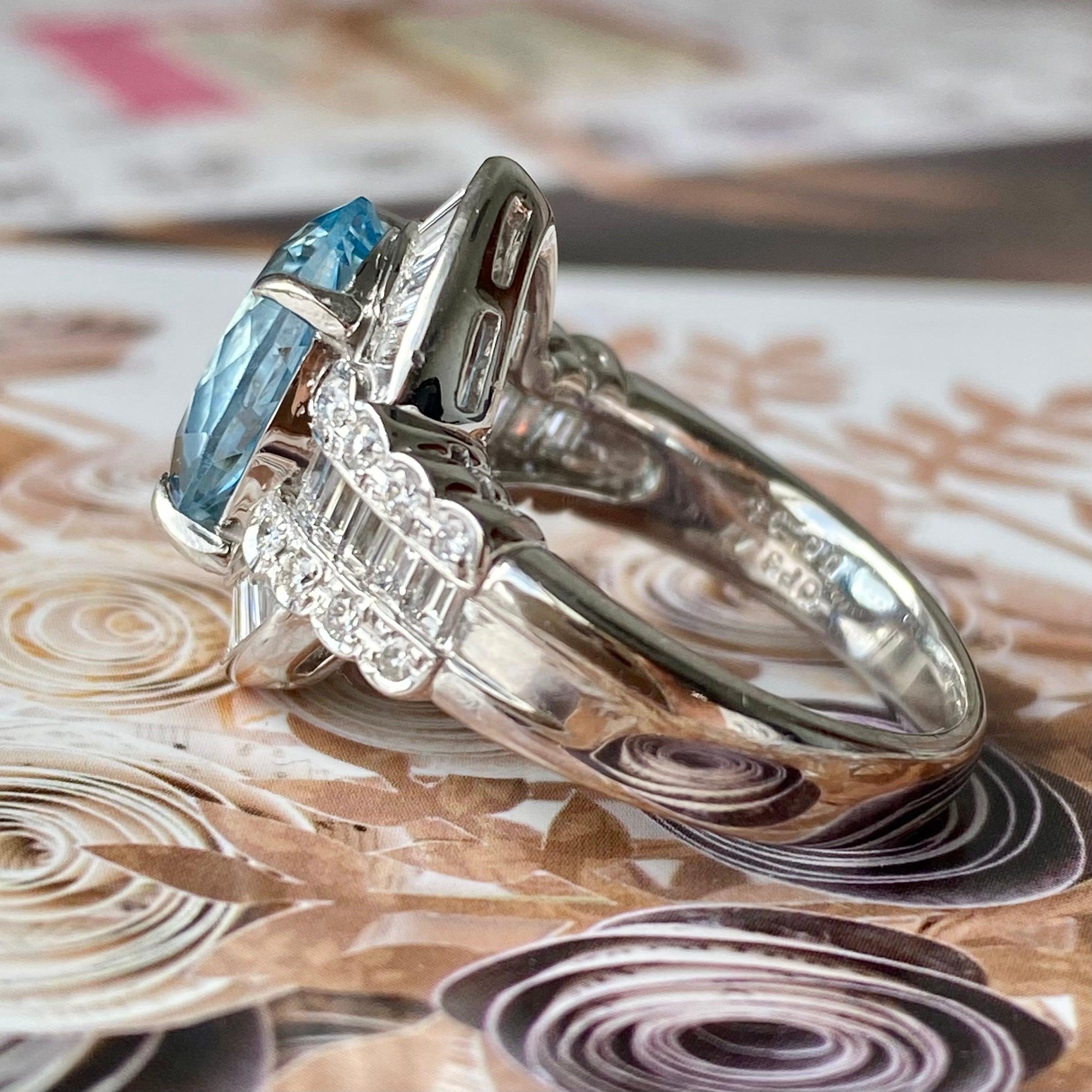 Crafted in platinum, the ring features an oval cut aquamarine surrounded by baguette and round cut diamonds in an elegant low profile setting.
Aquamarine: 4.0 carat
Diamonds: 0.95ctw. Color: G-H, Clarity: VS1-SI1
Measurements:
Front width: 18.5