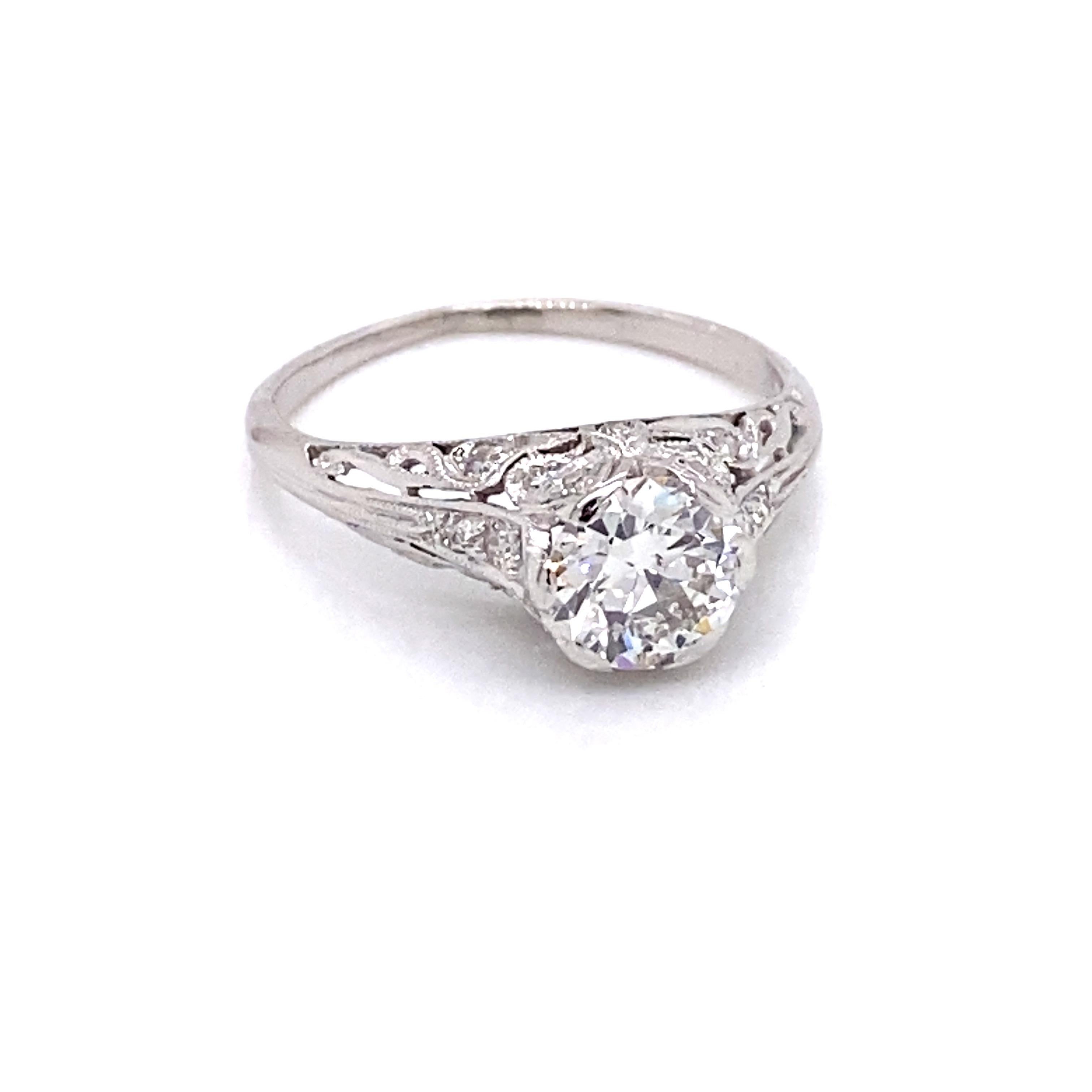 Vintage Platinum Art Deco Diamond Engagement Filigree Ring - The center European cut diamond weighs approximately 1.31ct and has the quality of M color and VS2 clarity. The diamond sits high in a platinum early Art Deco filigree setting that