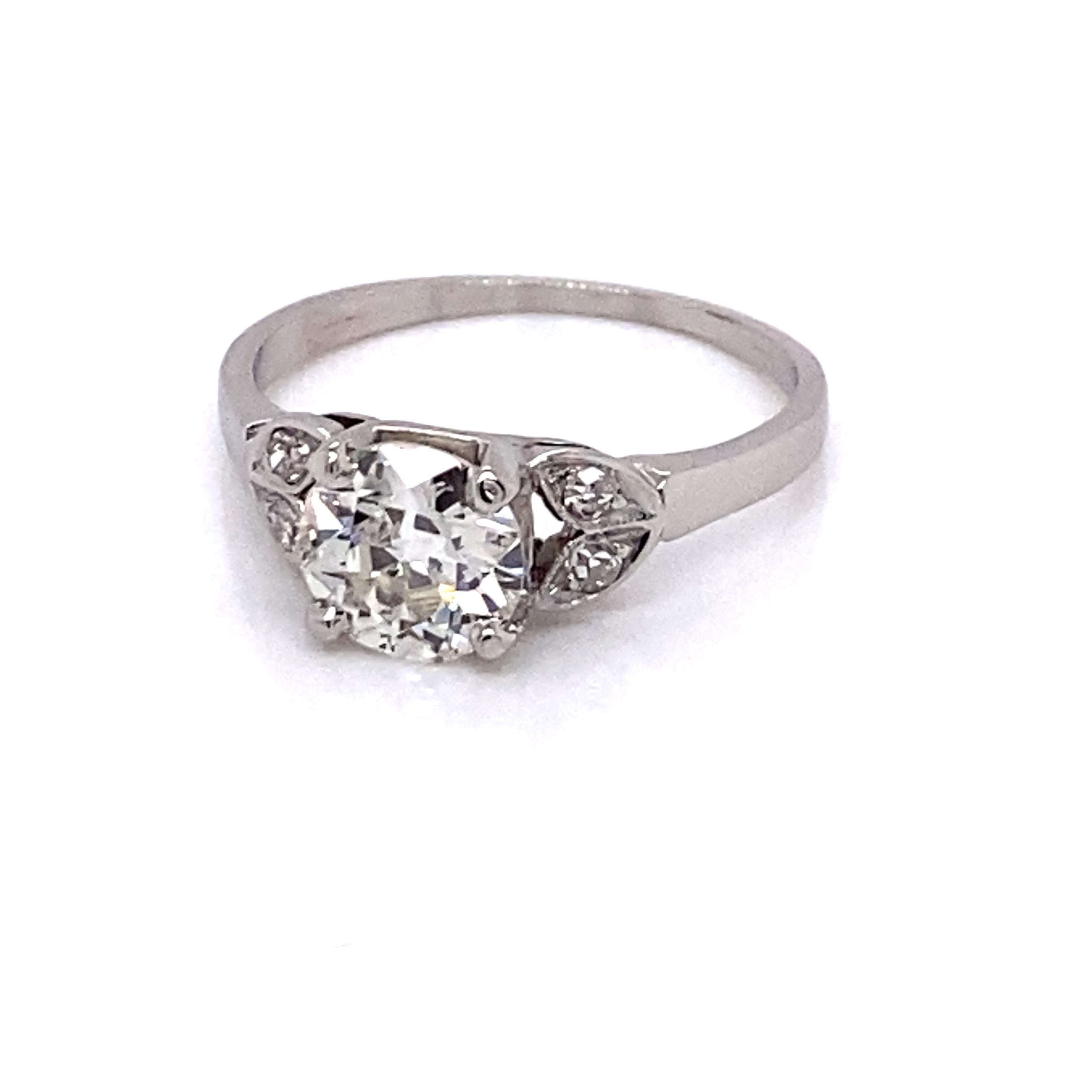 Vintage Platinum Art Deco Diamond Engagement Ring - Center Eurpean cut diamond weighs 1.01ct with J color and SI1 clarity. The diamond is set in a platinum 4 prong head and is accented with 2 leafs on each side with 1 single cut diamond in each leaf