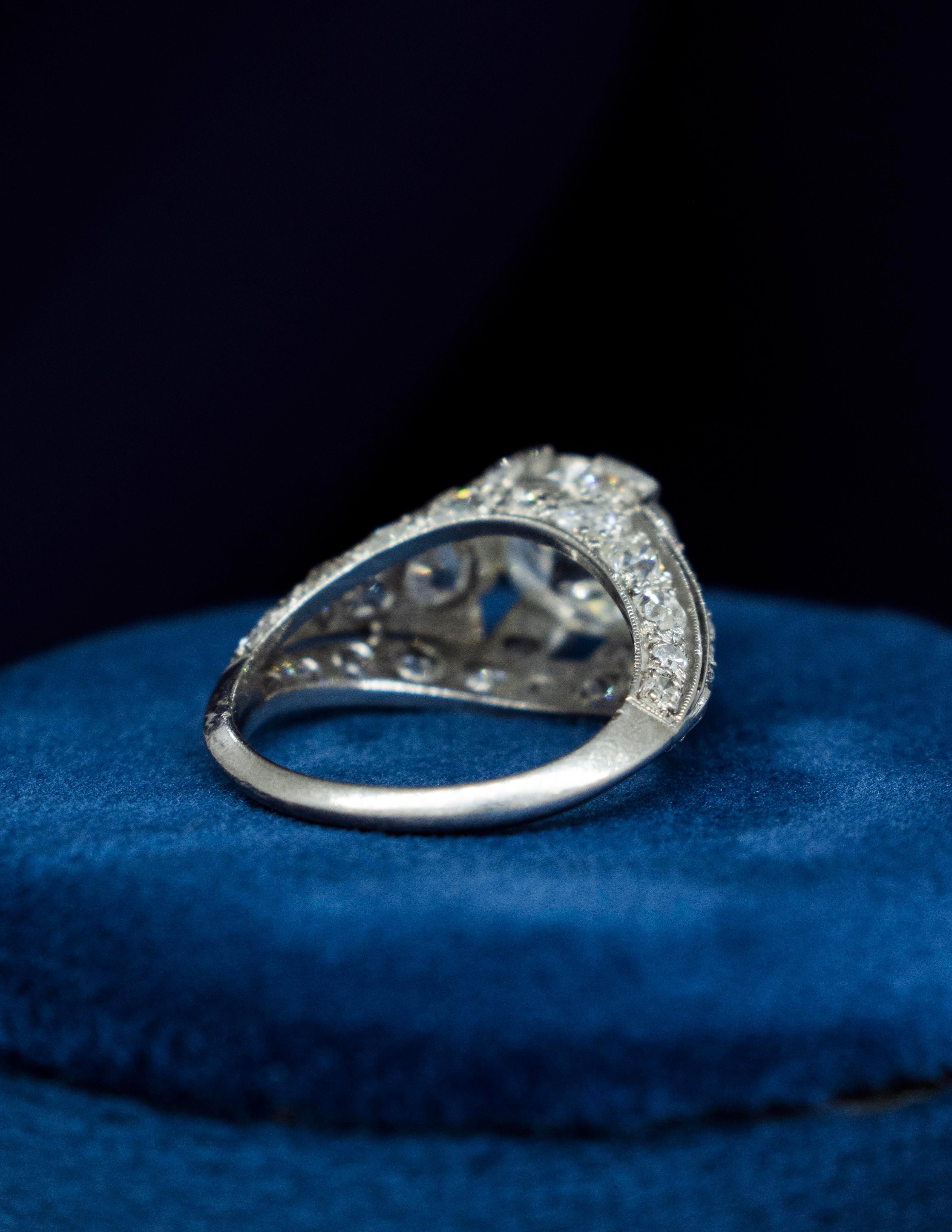 A fabulous ladies Platinum Art Deco Diamond engagement ring from the 1930's. The center Diamond is an old European Cut Diamond that is very symmetrical with excellent brilliance. It weighs approximately 2.50 carats (by measurement). It is an