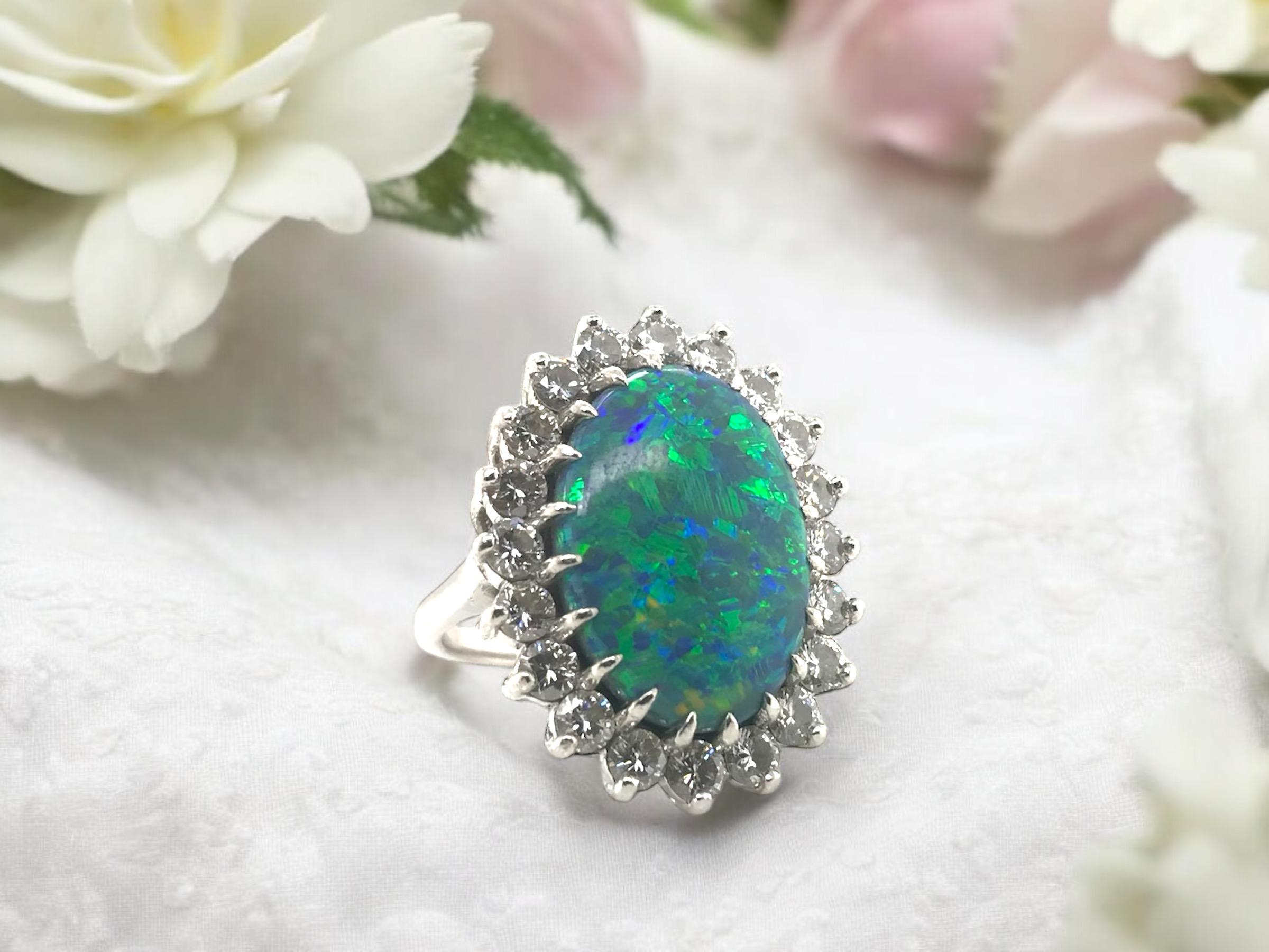 We are truly stunned by this beauty!!
The center black opal is perfection!!

Ring Details
Material: Platinum
Head Length: 26.7mm
Head Width: 21.0mm
Head Height: 9.2mm
Shank Width: 2mm
Weight: 18.0 Grams
Finger Size: 7

Accented by the following