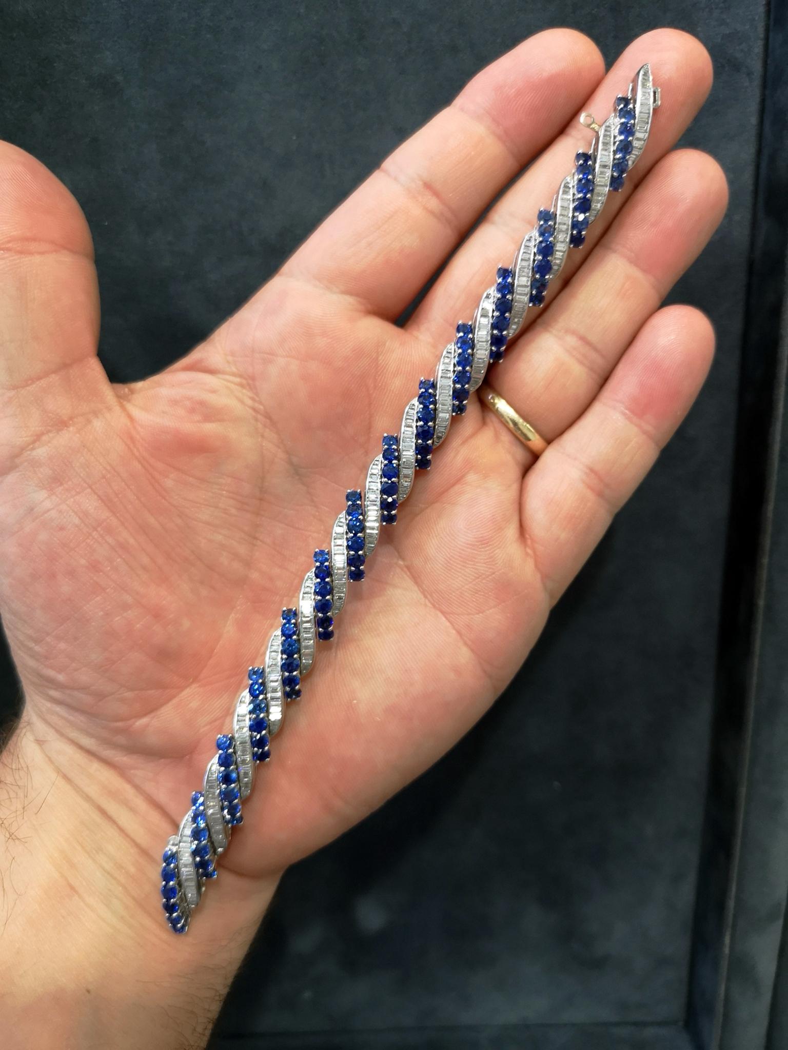 An exquisite, high quality platinum bracelet set with alternating diagonal rows of claw-set, brilliant-cut blue sapphires and channel-set, baguette-cut diamonds. Approximately 10.00 carats of sapphires in total. Approximately 7.00 carats of diamond