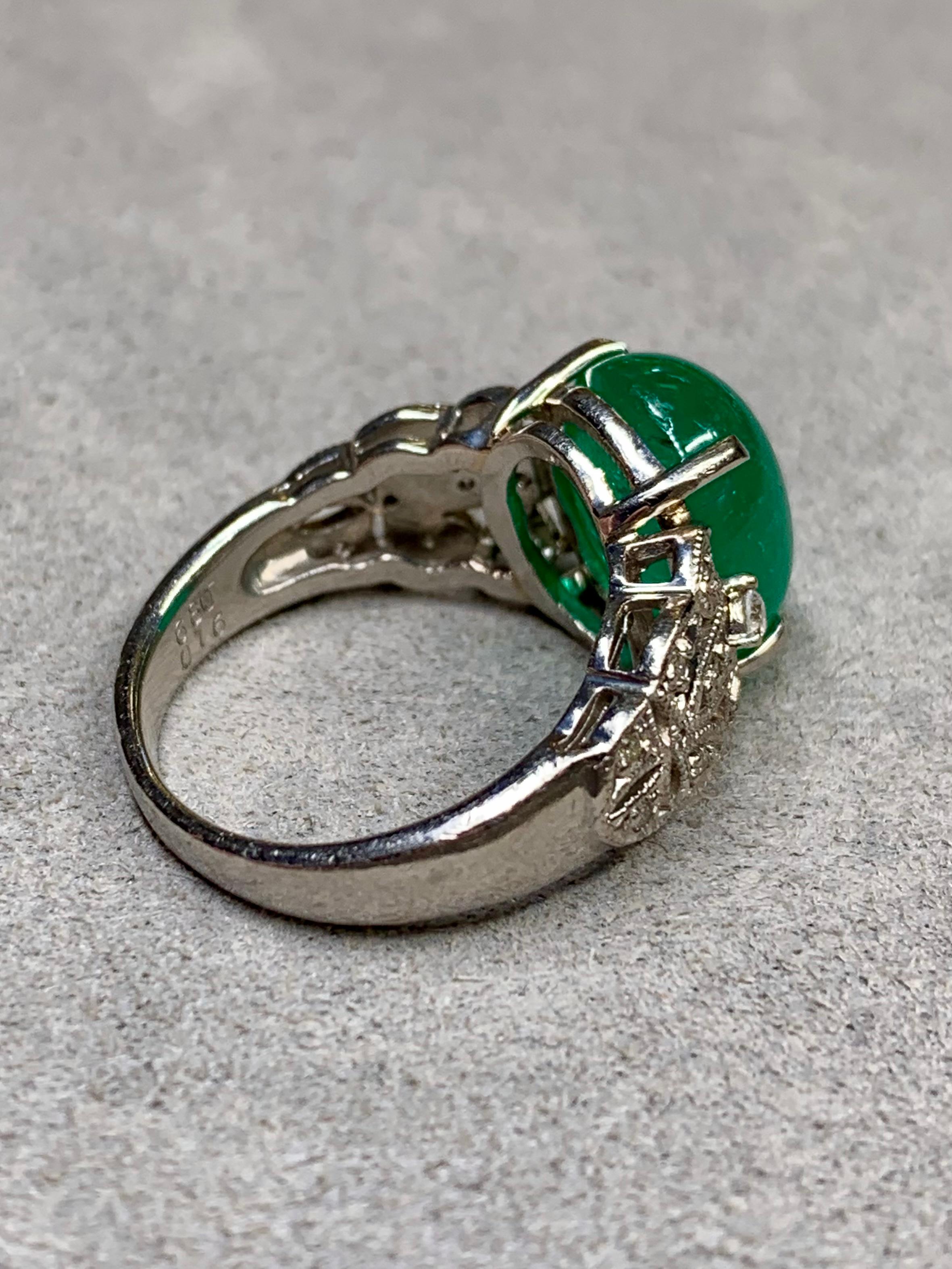 A gorgeous vintage ring circa the late 1950’s done in platinum and centered by a 6.80ct natural Colombian cabochon emerald that simply glows! It is flanked by .16ctw in G-I color Vs2-Si1 clarity round diamonds. The sale of this ring is accompanied