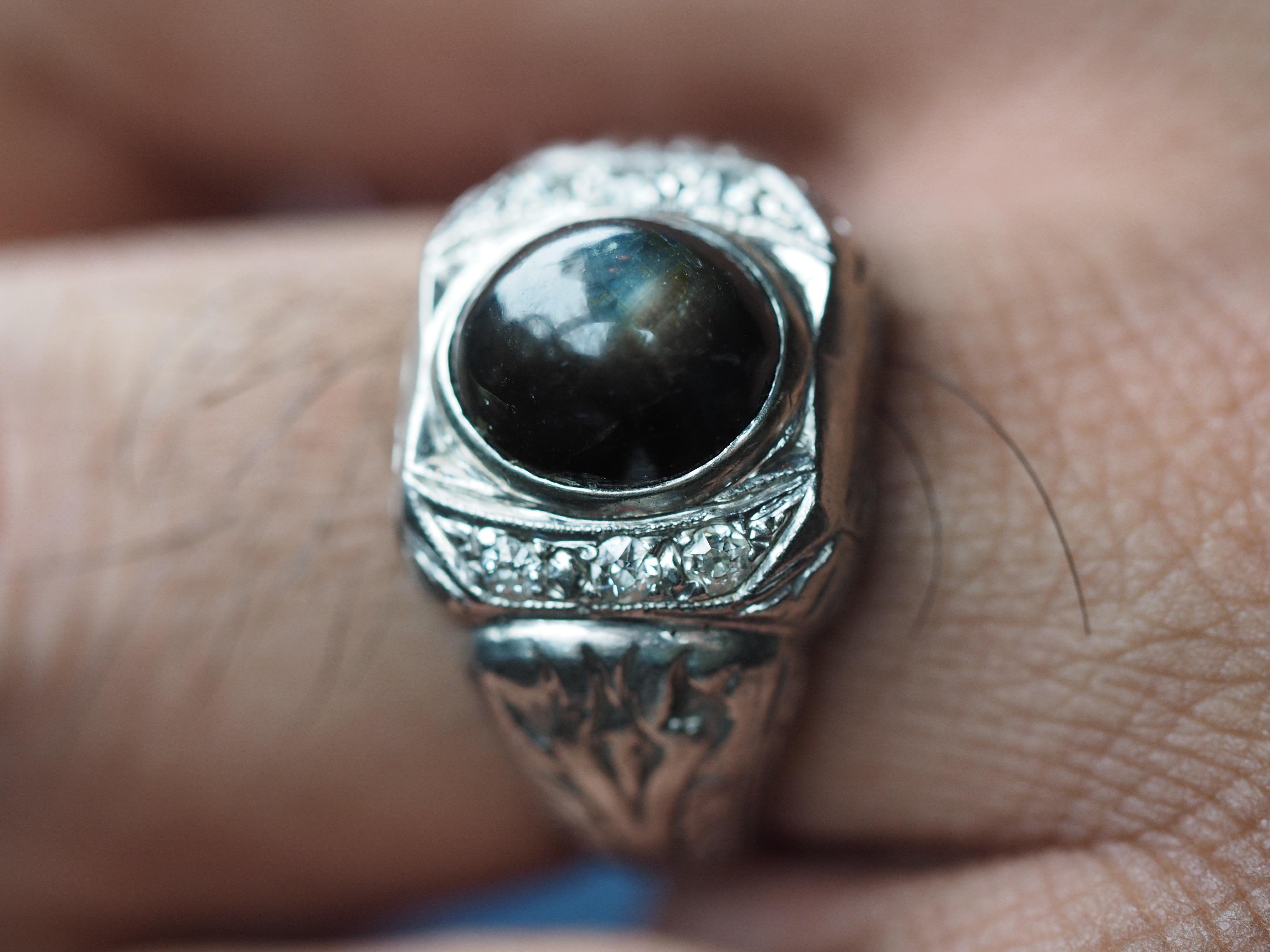 This Vintage men's platinum ring dates back to the 1980's. The heavy platinum ring holds a black chrysoberyl also known as 