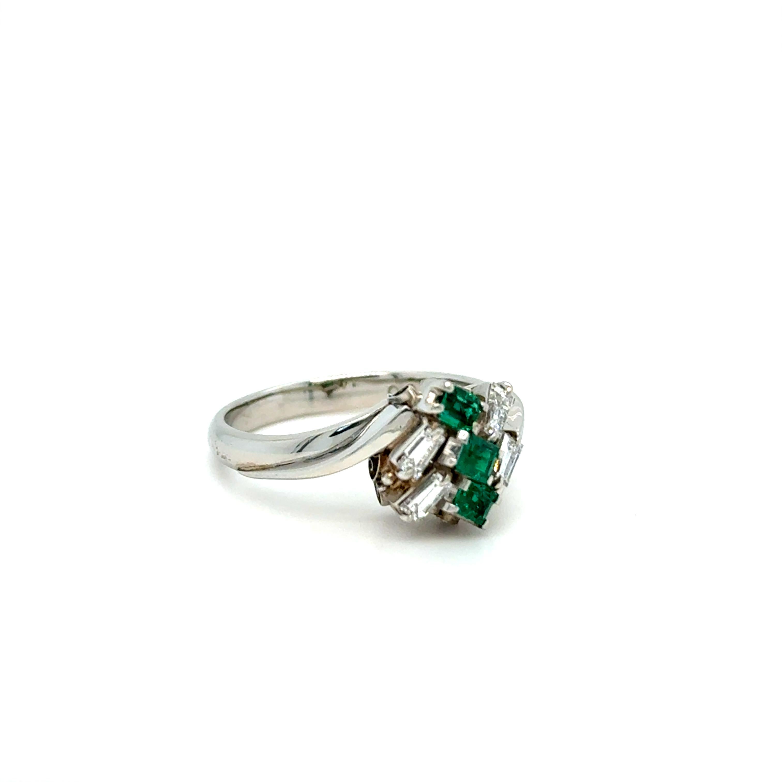 This gorgeous retro cluster has amazing gemstones, stunning sparkle, and great design. What a package! Crafted in Platinum, the cluster is made up of 3 Square Cut Natural Emeralds, 0.21ct, of fine qaulity. In addition, there are 4 Baguette Cut