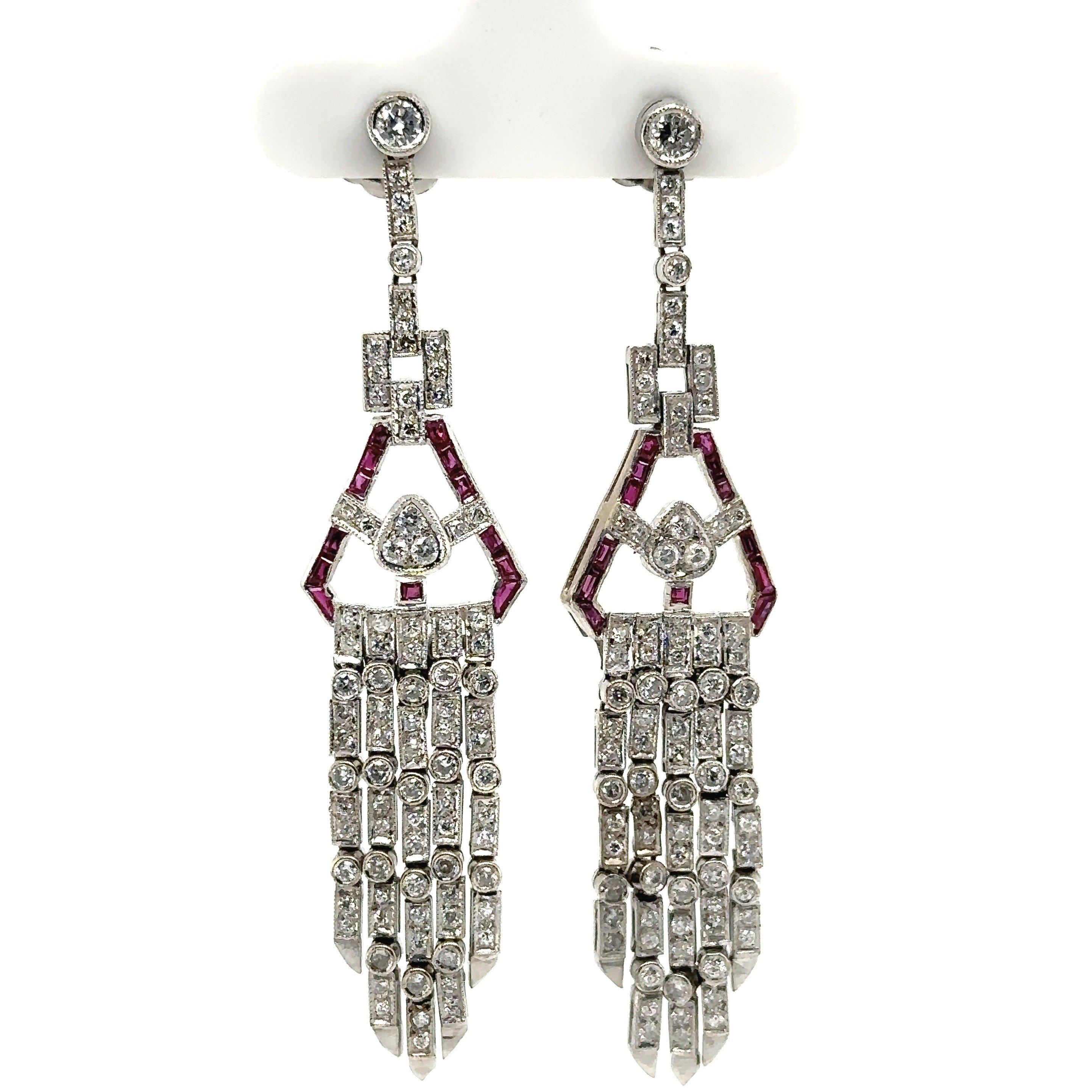 This stunning pair of platinum Art Deco style diamond and ruby chandelier earrings date from the 1950's. They contain approximately 1.5CT diamond total weight and  .60CT ruby total weight. The earring drop length is about 2.5