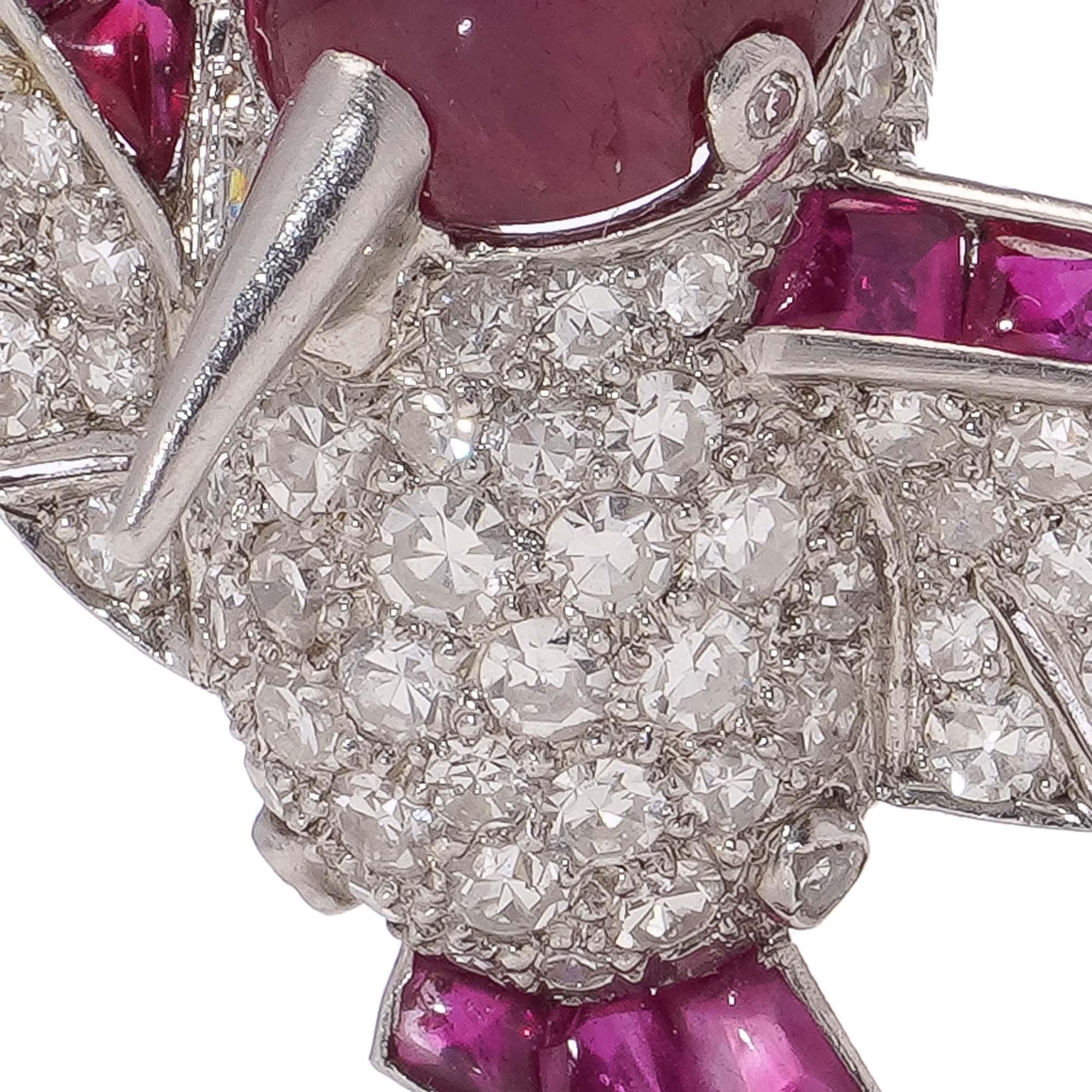 Vintage platinum diamond and ruby humming bird brooch.

This platinum bird brooch is made Circa mid - 20th century and showcasing a combination of rubies and diamonds. The bird's body is adorned with a cabochon ruby, representing the head, while its