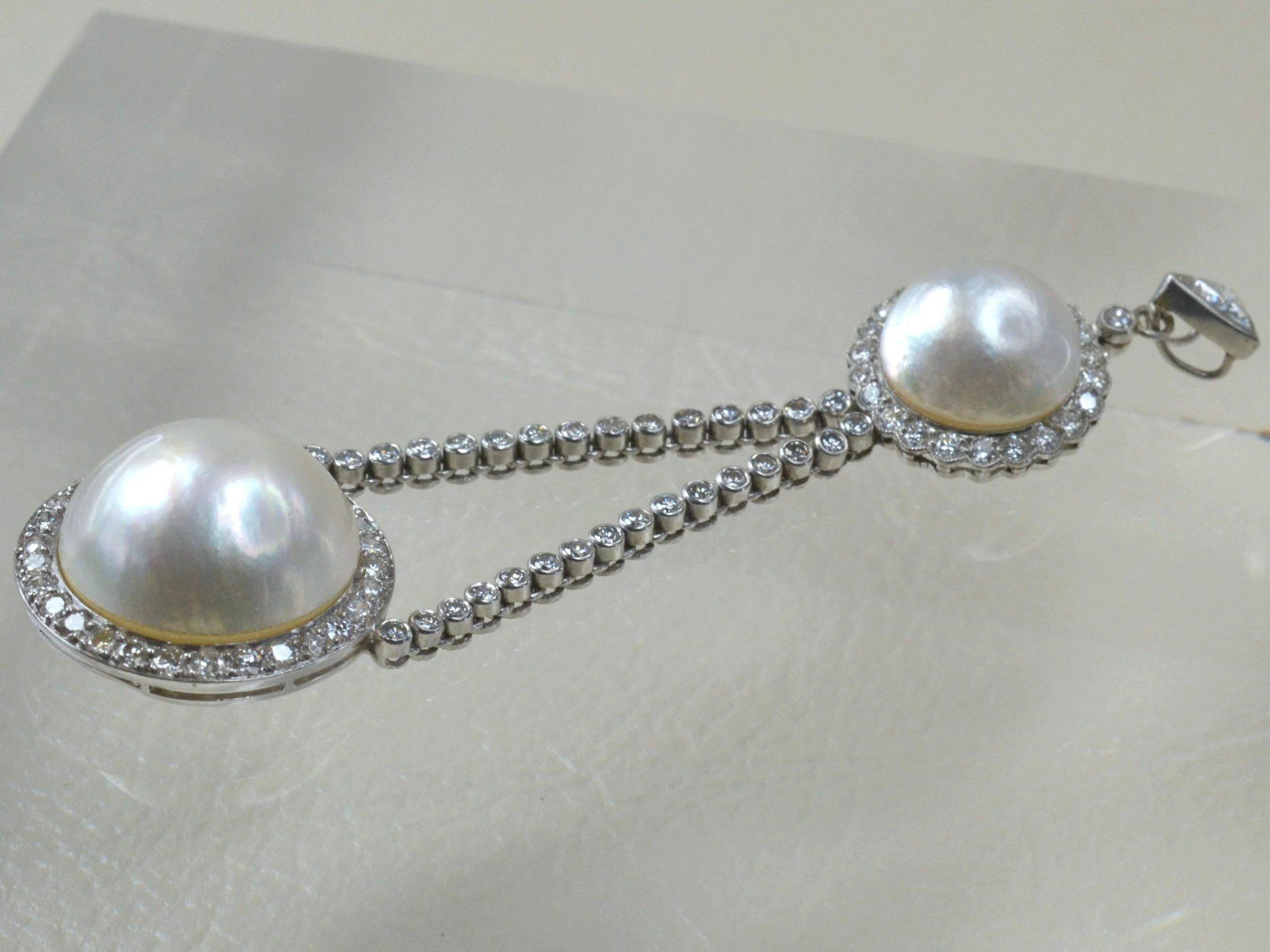 Large, 1970s Piece. Platinum, White Diamond and White, South Sea Double Pearl Pendant. 
Pendant features two large pearls, both halo set with soft, floral edges. Elegant, dazzling piece with movement.

Top smaller halo - Measures 1.5cm diameter.