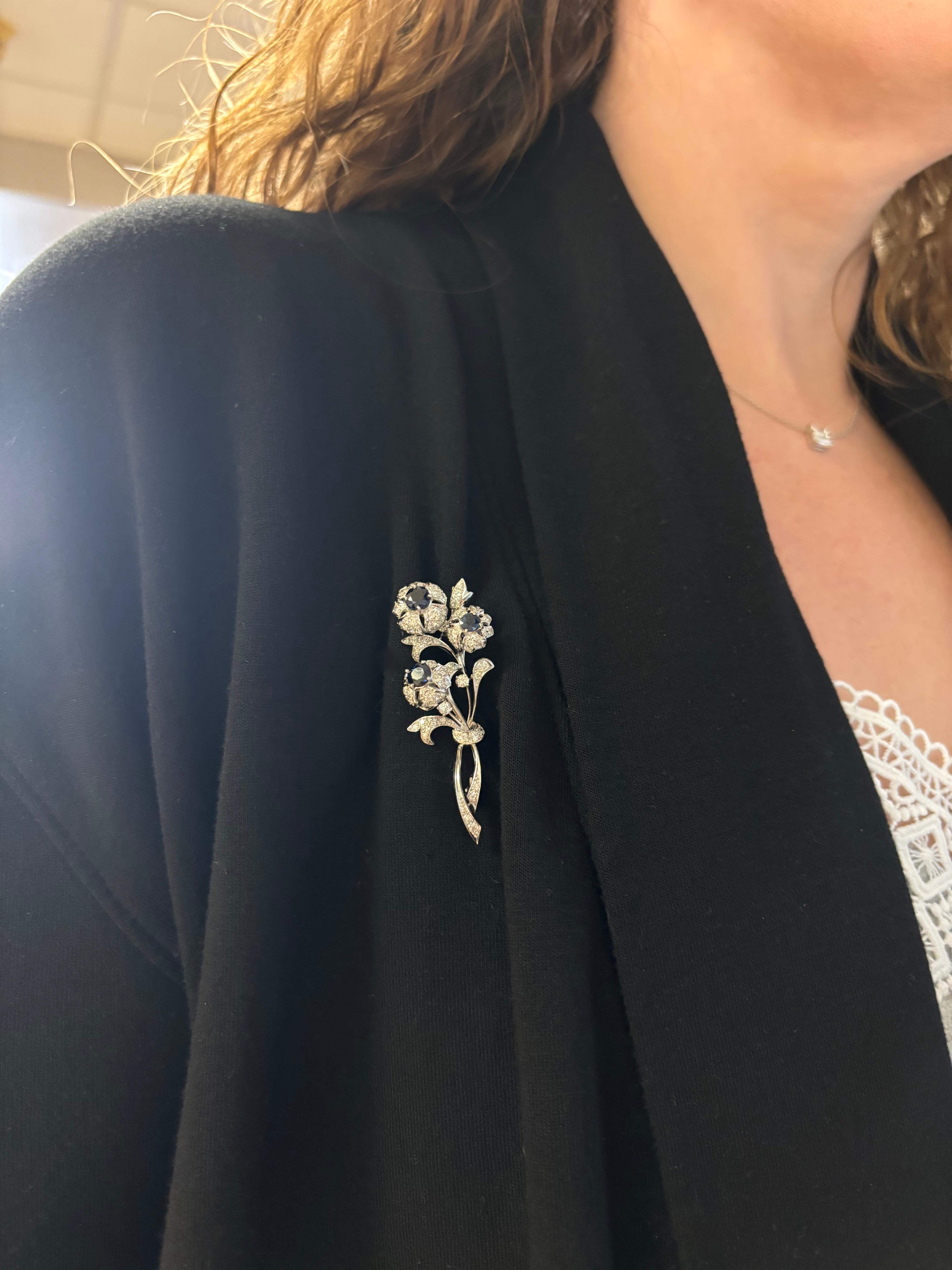 Vintage nosegay pin made in Platinum with Diamonds & Blue Sapphires. 

Diamond Carat Weight: 2.14CTW
Diamond Cut: Round Brilliant Cut Diamonds
Color: Average F-H
Clarity: Average VS-SI
Gemstone: Blue Sapphire
Gemstone Weight: 1.80CTW
Metal: Platinum