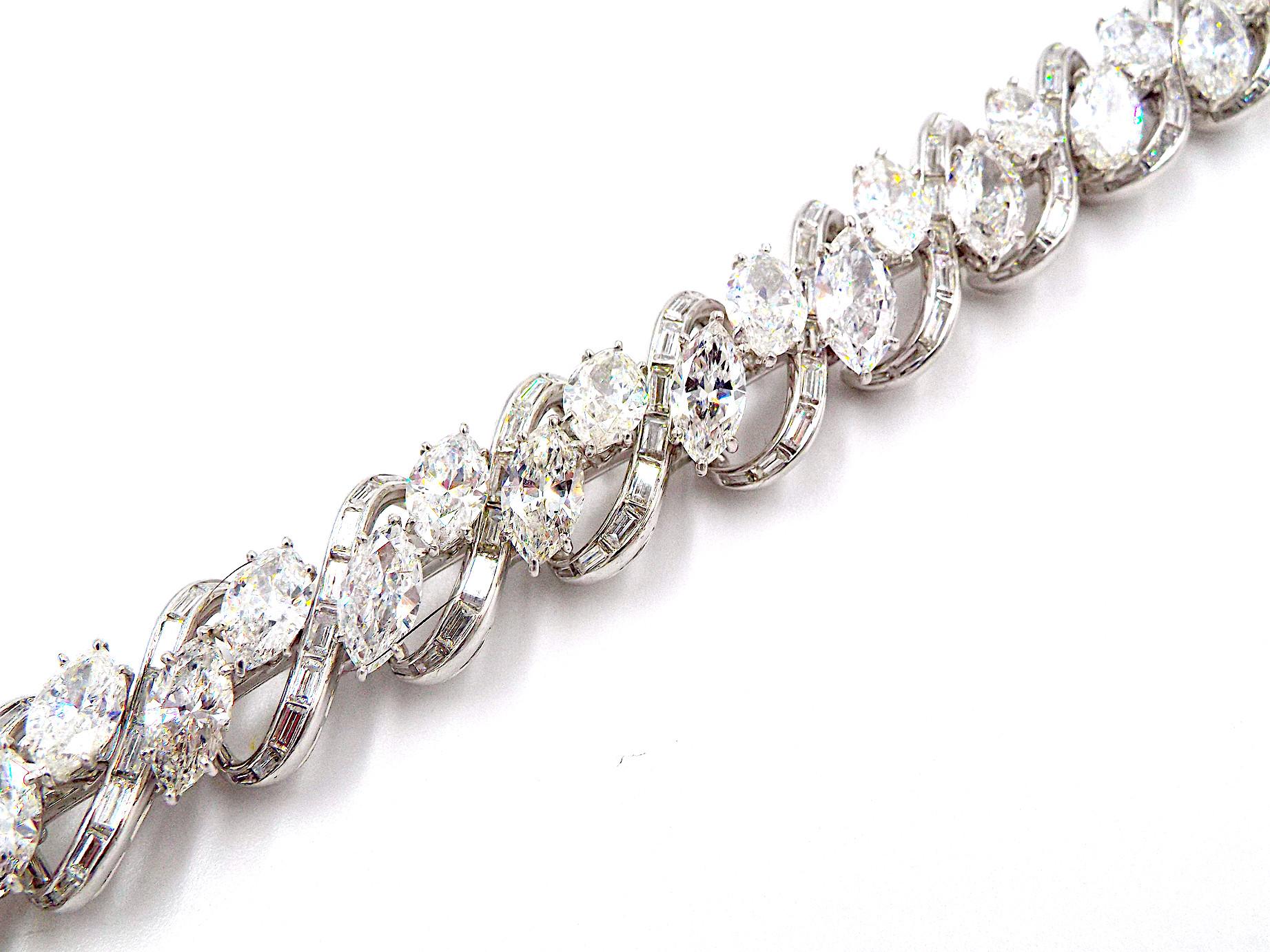 A diamond bracelet of openwork design, centrally set with marquise-shaped diamonds, accented by a stylized woven design, set with baguette-cut diamonds; estimated total diamond weight: 30.00 carats; mounted in platinum; length: 7in. Marquise-cut