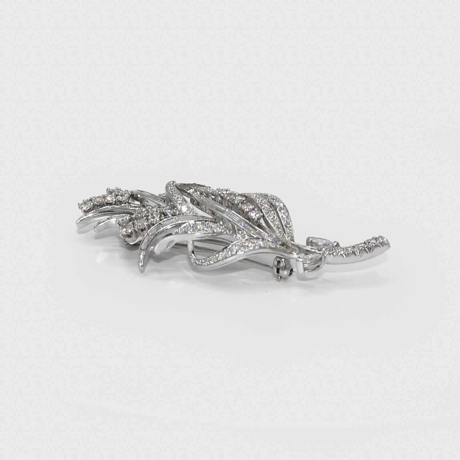 Vintage Platinum Diamond Brooch 2.00tdw, 15g
Ladies vintage platinum and diamond brooch.
Tests platinum with electronic tester and weighs 15.1 grams.
Attractive floral design.
The diamonds are round brilliants and baguette cuts, 2.00 total carats, G