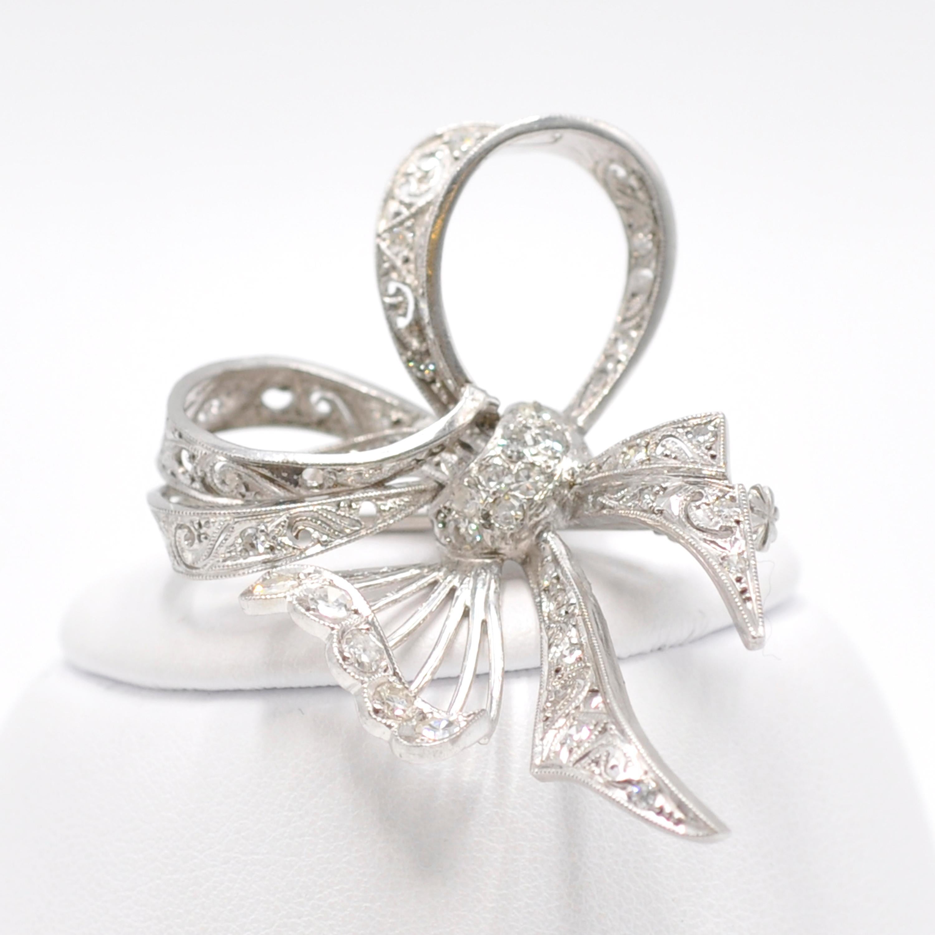 Compliment your favorite dress or sweater with this elegant vintage platinum diamond bow pin. The curves of the bow twist themselves to suggest a butterfly and are accented by the scroll design on the ribbons.
1 carat of diamonds are sprinkled