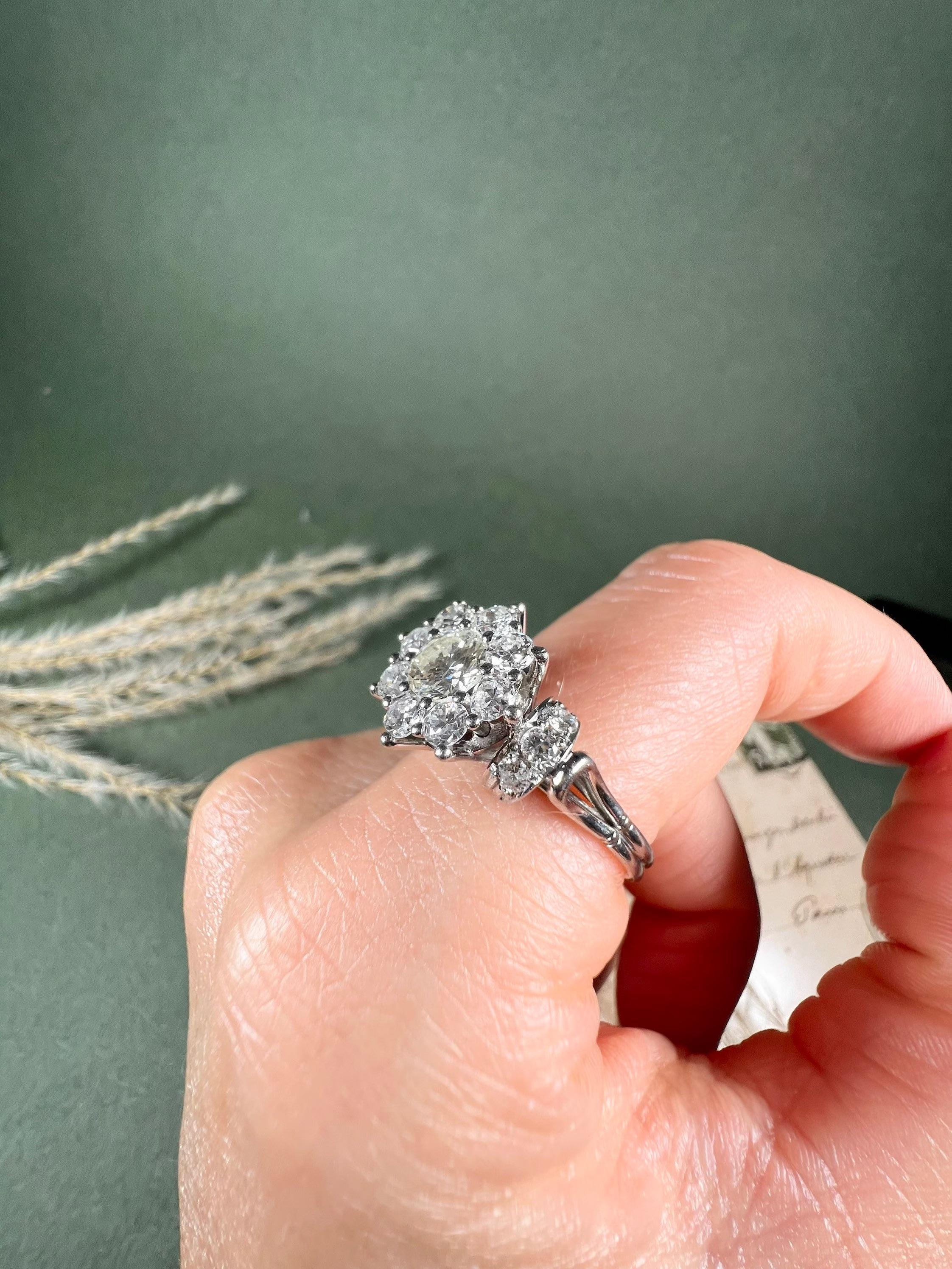 Vintage Diamond Ring 

Platinum 

Circa 1980’s

Fabulous sized, vintage diamond ring. Set with a gorgeous cluster of modern brilliant cut, claw set diamonds & pretty diamond shoulders. All natural stones, mounted on a platinum, looped shank. 

Would