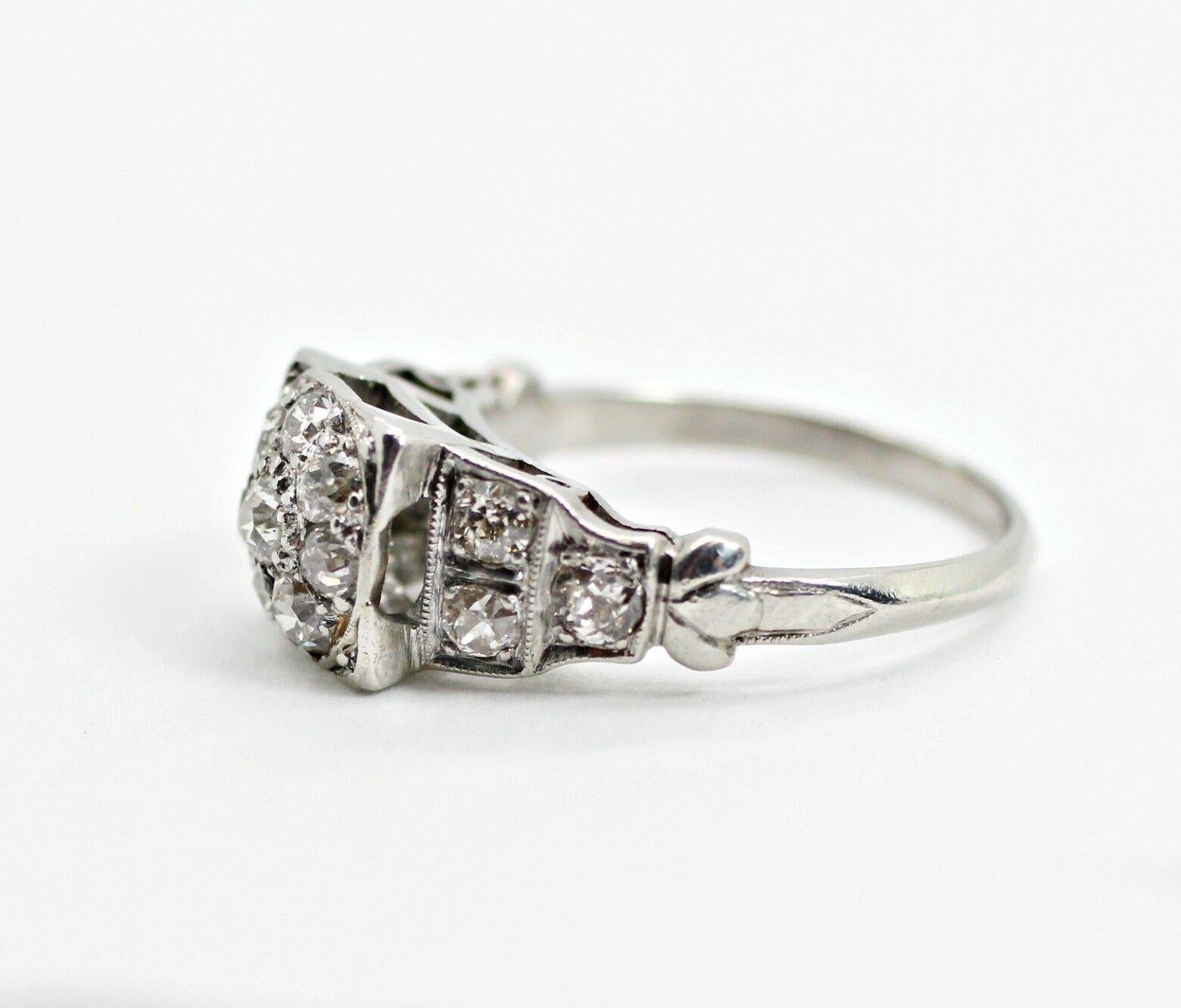 A vintage platinum diamond cluster ring, popular in the mid-20th century, with 14 pieces old miner rounds, approximately 1.12 in carat total weight. The diamonds are I in color, and VS2 - SI1 in clarity. It's current ring size is 5.25 US but can be