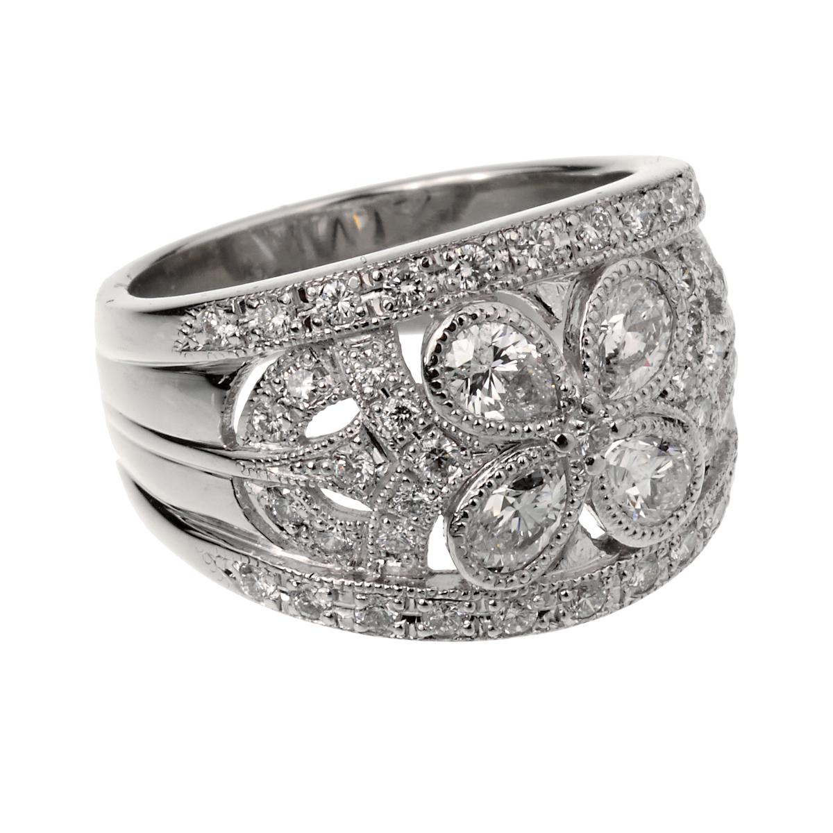 A fabulous vintage cocktail ring showcasing 4 pear shaped diamonds adorned with round brilliant cut diamonds in shimmering platinum. The ring measures a size 6 1/4 and can be resized.