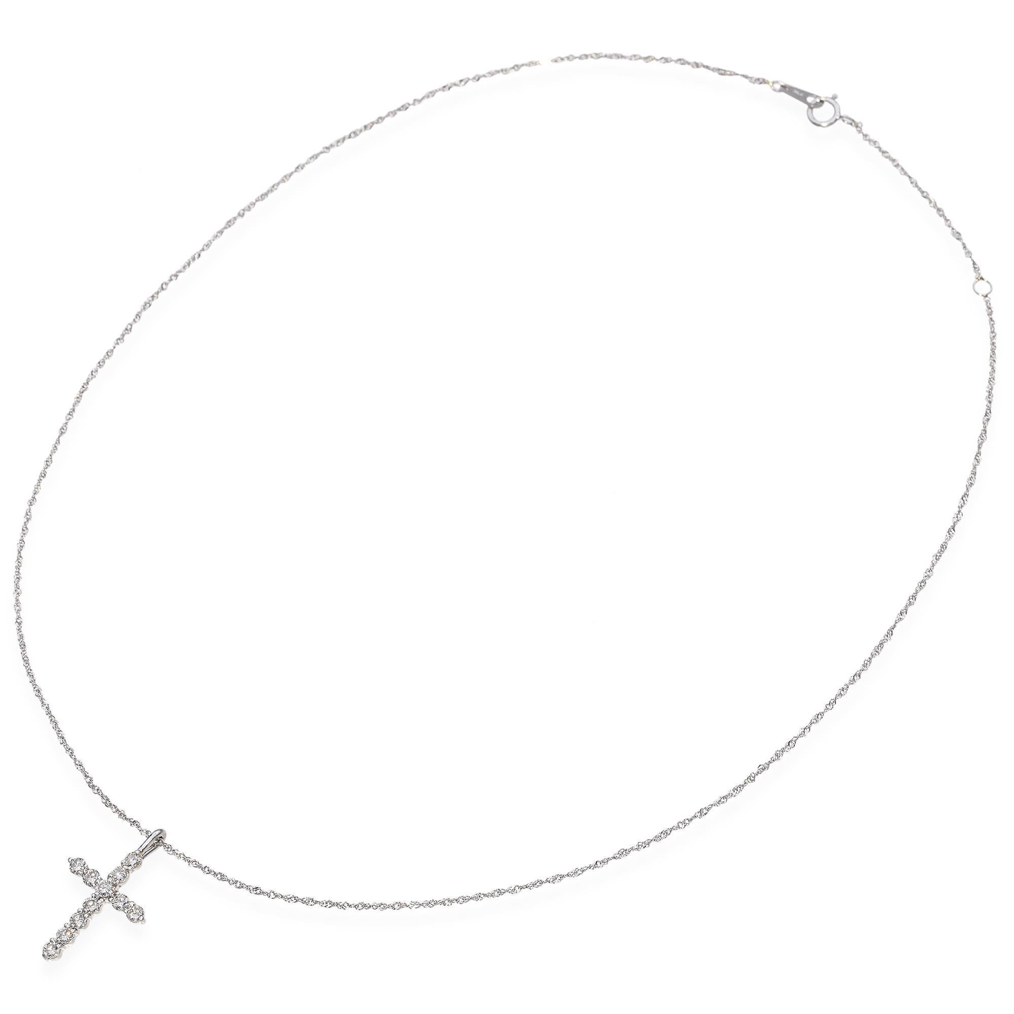 This vintage platinum cross pendant is adorned with sparkling diamonds, creating a radiant and timeless piece. The sleek platinum setting adds a touch of refined elegance and durability. Each diamond is carefully set to enhance brilliance and