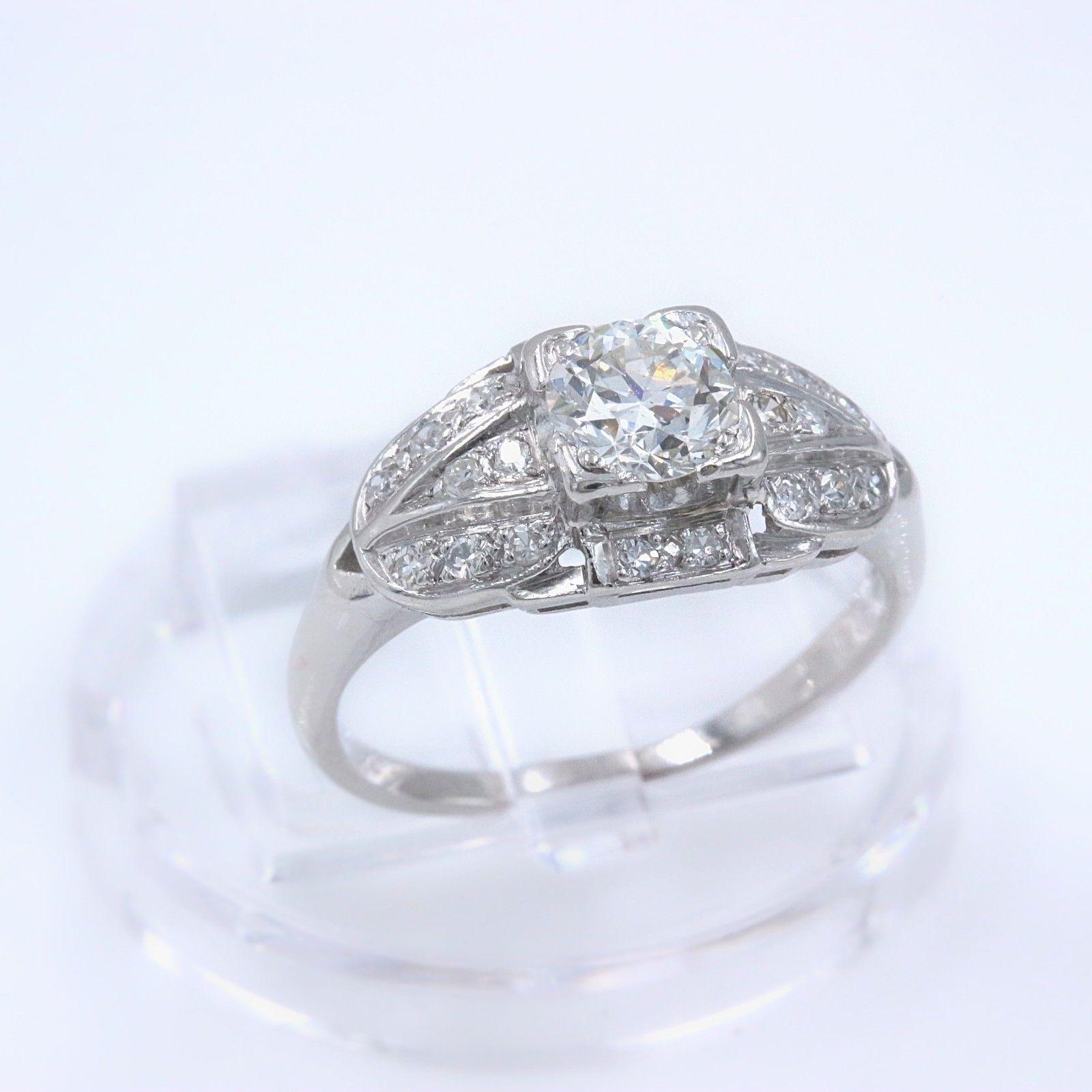 OLD CUT DIAMOND ENGAGEMENT RING

Style:  Solitaire with Side Stones
Metal:  Platinum
Size:  5 - sizable
Total Carat Weight:  1.08 twc
Diamond Shape:  Old Cut Round 0.58 cts H color, SI1 clarity
Accent Diamonds:  20 Old Cut Diamonds 0.50 tcw H color,