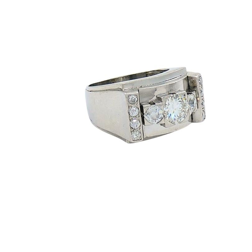 A vintage platinum diamond ring featuring a tank design. The diamonds include round brilliant and single cuts, with three central diamonds set horizontally, flanked by smaller diamonds arranged vertically in rows of four on each side. The central