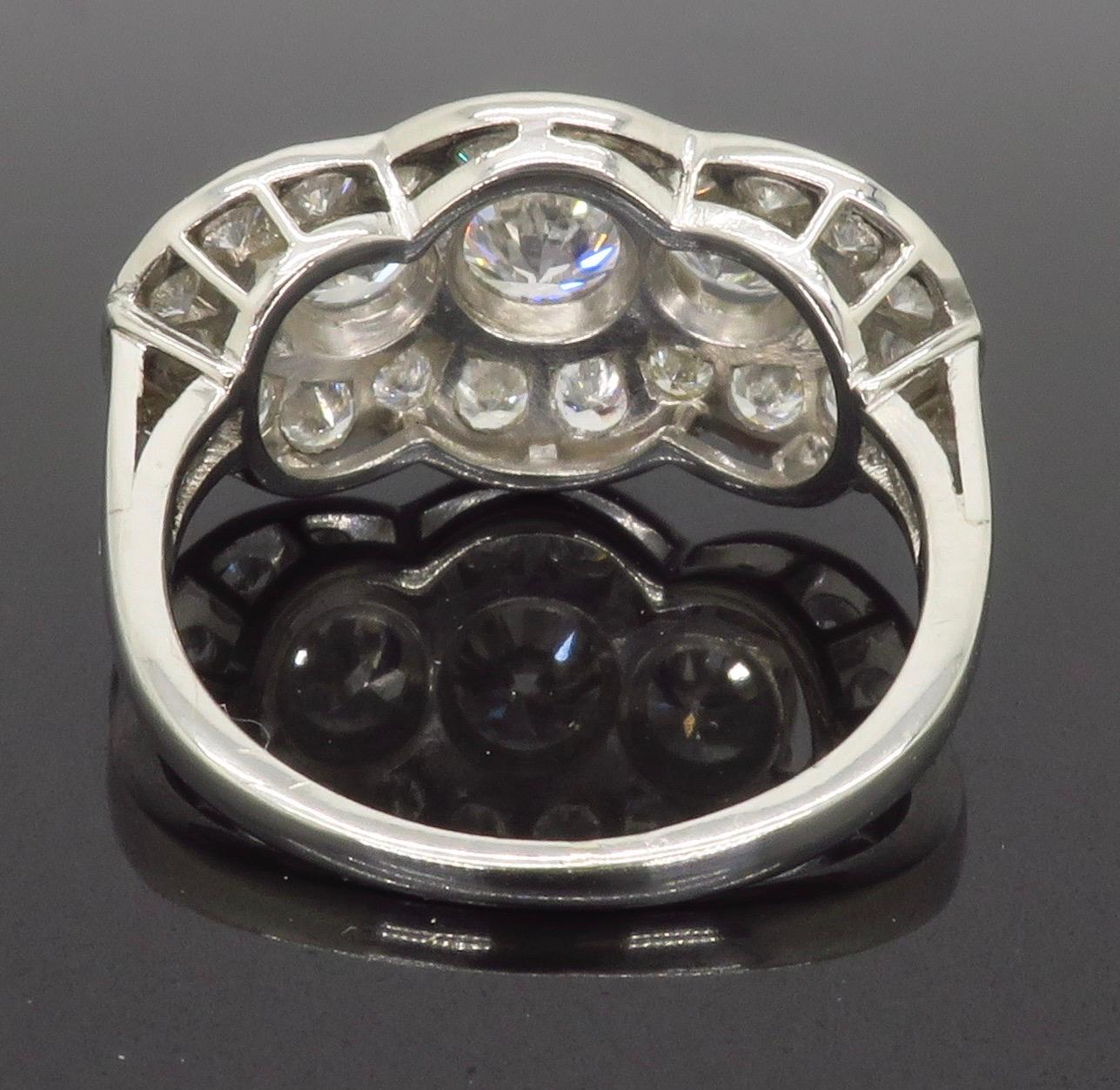 Round Cut Vintage Platinum Diamond Three-Stone Halo Ring