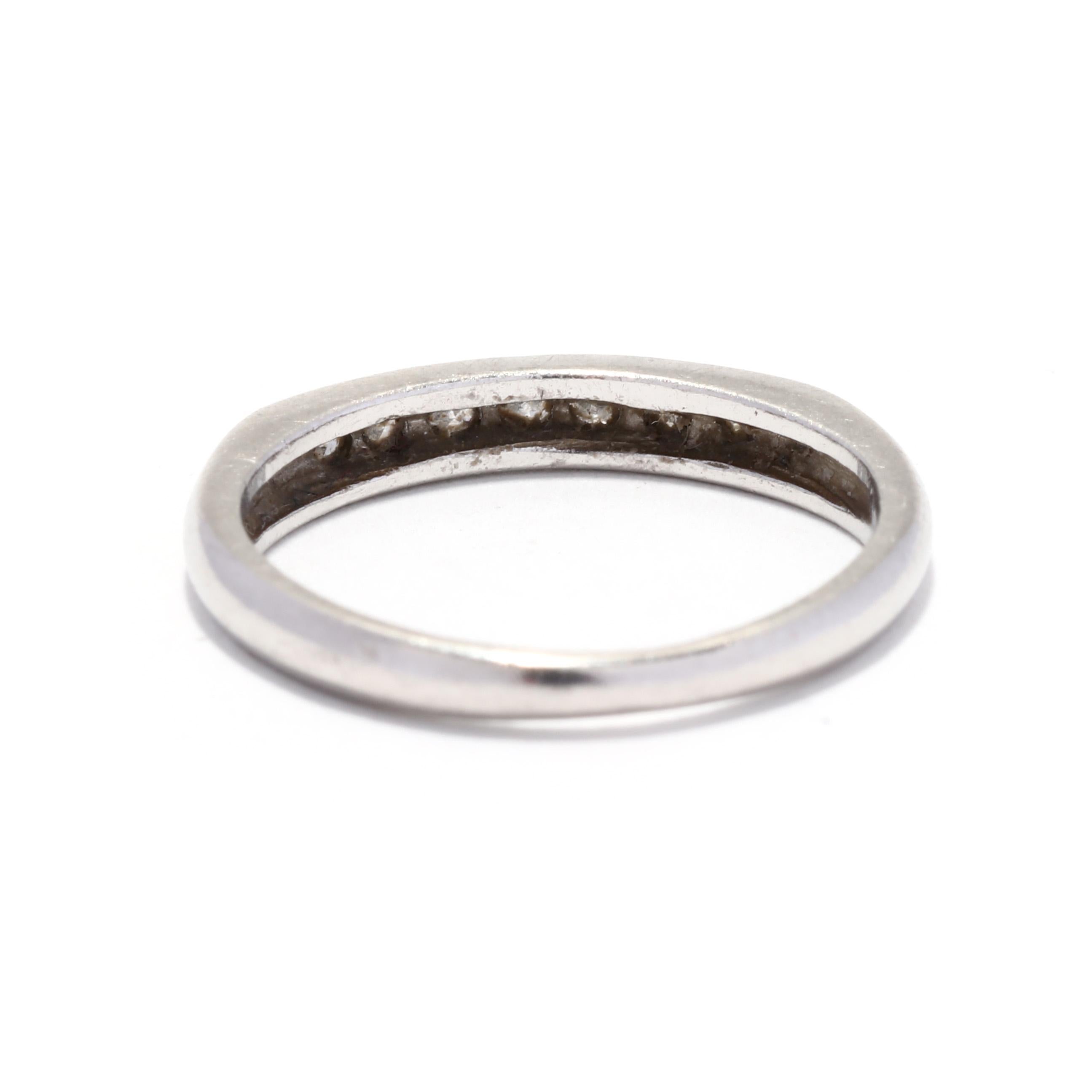 A vintage platinum and diamond wedding band. This stackable band features seven channel set single cut round diamonds weighing approximately .12 total carats and with a thin tapered band.

Stones:
- diamonds, 7 stones
- single cut round
- 1.75 mm
-