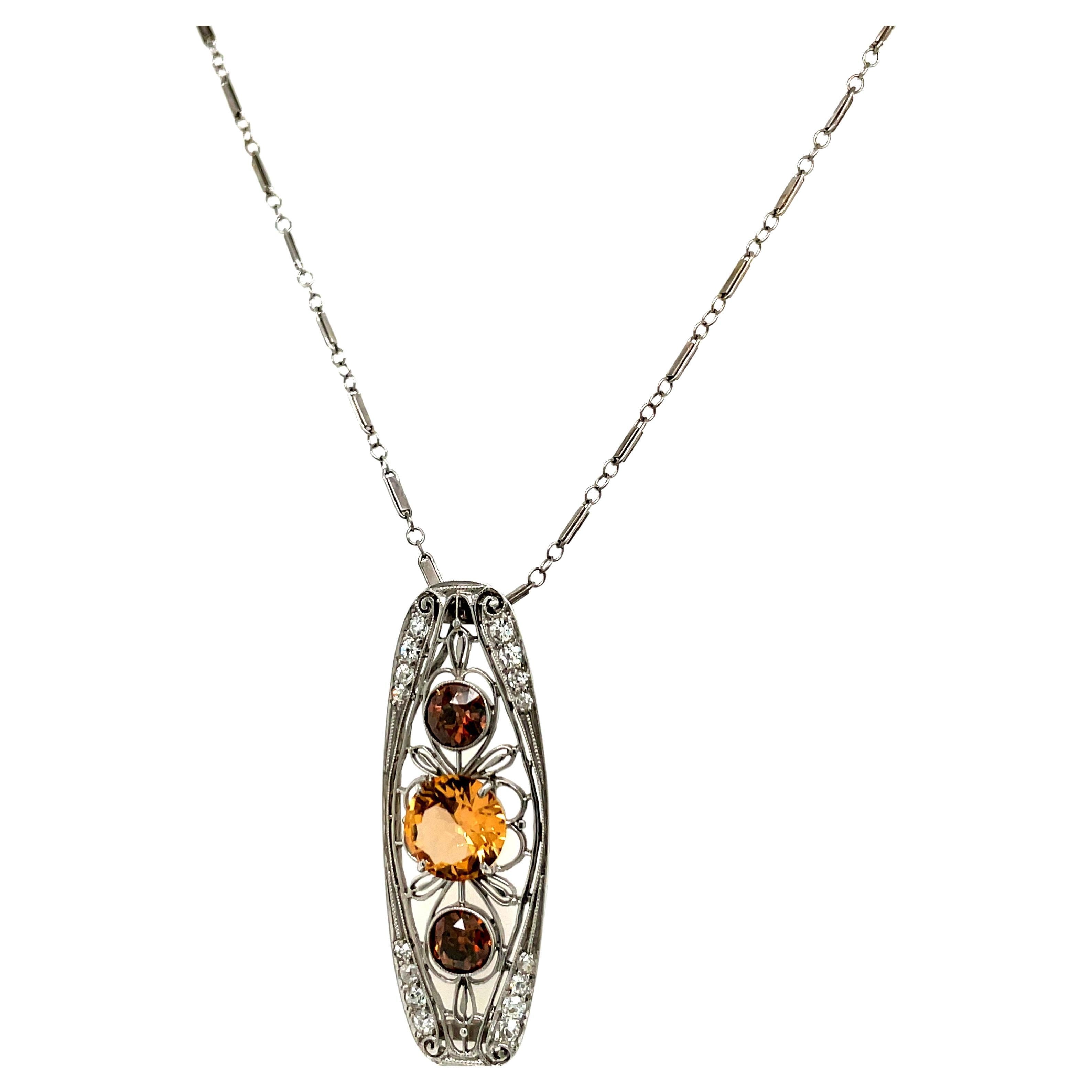 This exquisite vintage pendant is a true masterpiece of intricate artistry and rare gemstone beauty. Rendered in lustrous platinum with delicate filigree detailing, it showcases an exceptional combination of a golden-hued precious topaz and warm,