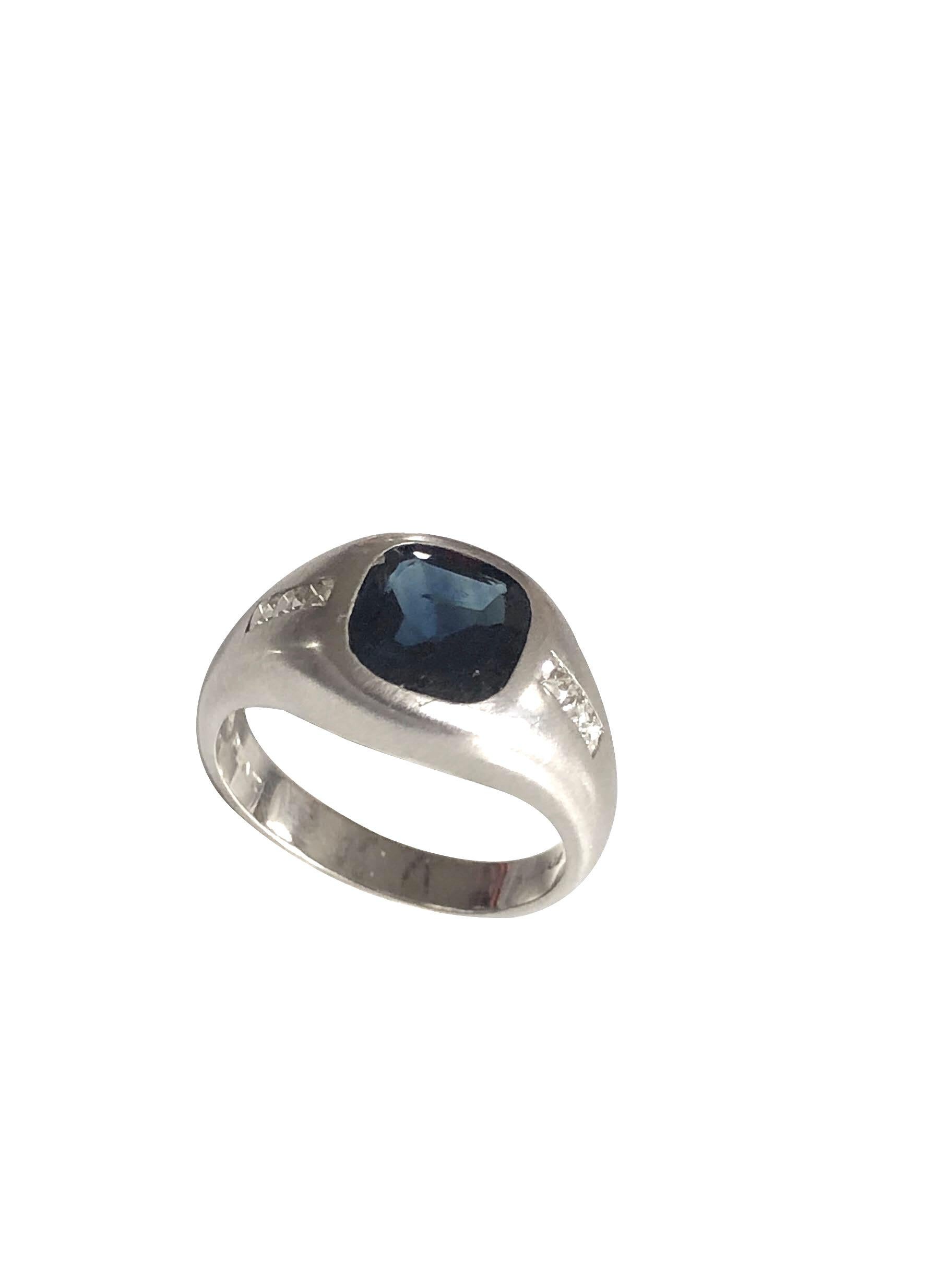Circa 1930s Art Deco style Platinum Ring, centrally set with a Deep Blue Cushion Sapphire measuring 6.8 X 6.8 M.M. approximately 2.50 Carats, further set on either side with very fine white in color French cut Diamonds totaling approximately .20