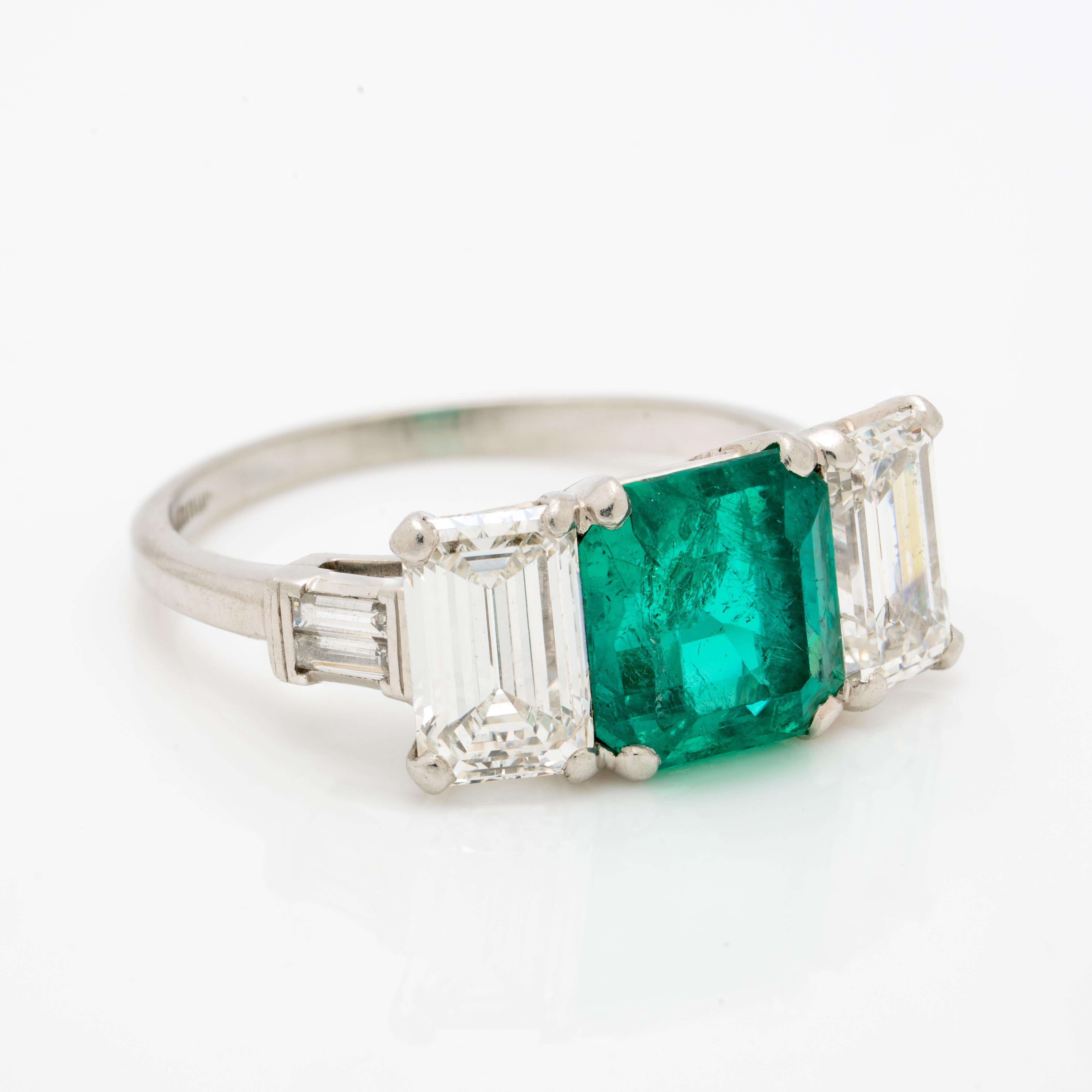 Vintage Platinum GIA certed 1.20ct Colombian Emerald RING w/ 1.0ct Emerald Cut Diamond Shoulders c.1950s

Period: Vintage
Year: c. 1950s
Material: Platinum, 1.20cts.Colombian Emerald and 1.10cts Emerald Cut and baguette cut Diamonds
Size: 7
Weight: