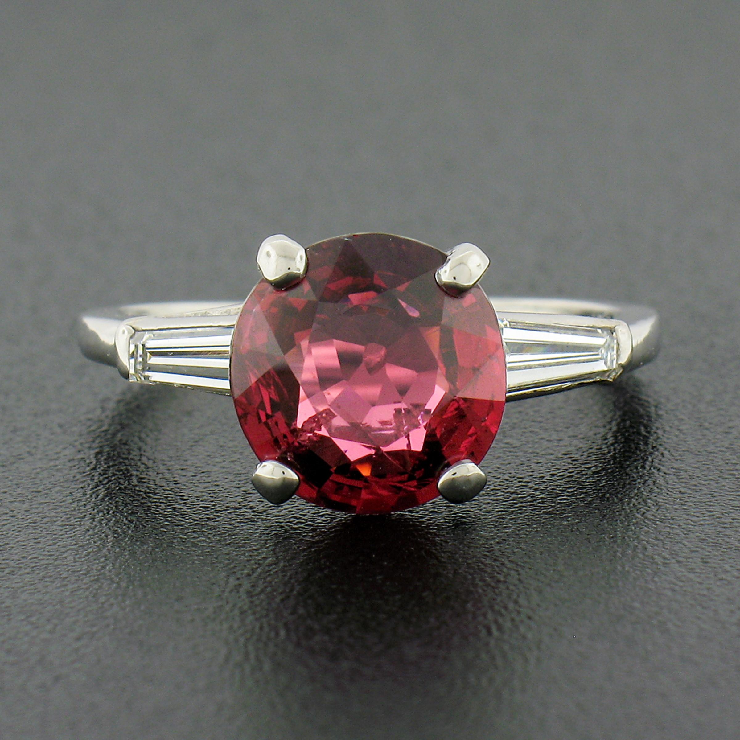 This outstanding vintage ring was hand crafted from solid 950 platinum and features a gorgeous, 2.78 carat, GIA certified red spinel prong set at its center. This magnificent deep red spinel has been certified by GIA as being a 100% natural stone,